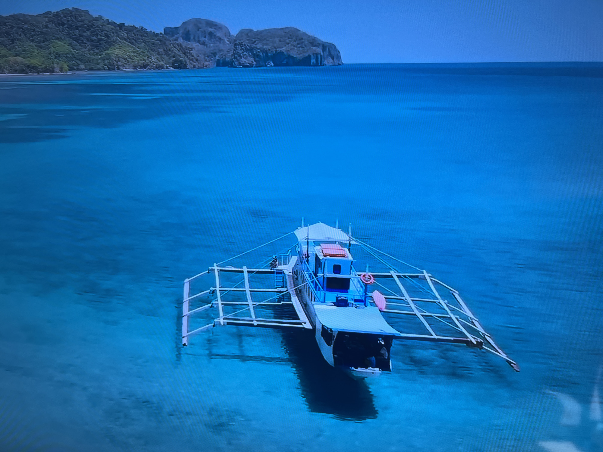 The image shows a boat in a body of water. In the background, there is land. There is nothing to indicate that this image is located in Basingstoke and Deane, United Kingdom.