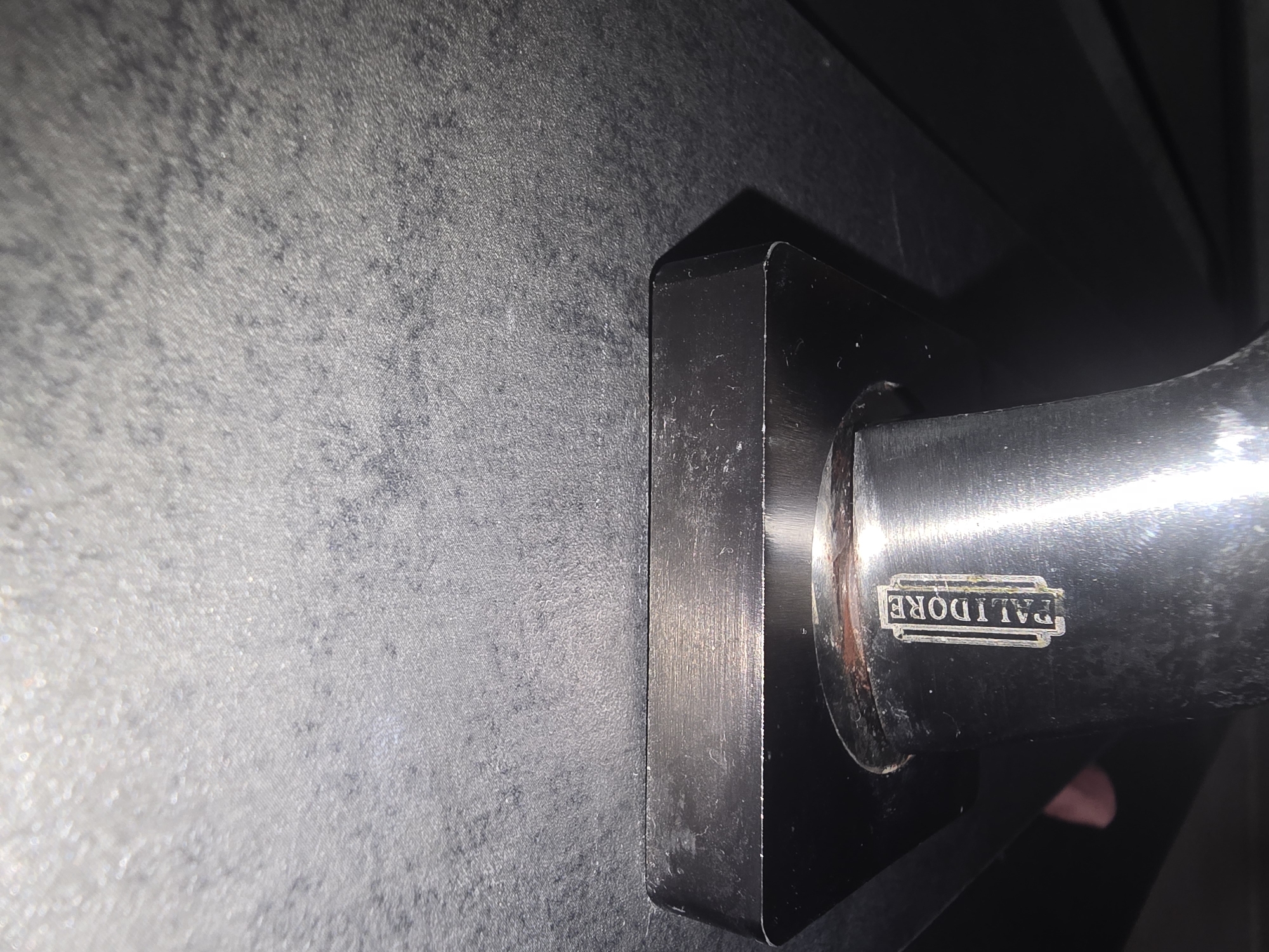 The image shows a close-up of a metallic handle with the brand name "PALIDORE" embossed on it. The handle appears to be attached to a dark, possibly textured surface. The lighting suggests an indoor environment, and there are some smudges or imperfections on the metallic surfaces. No specific location within Ulan-Ude, Russia, can be determined from the image.