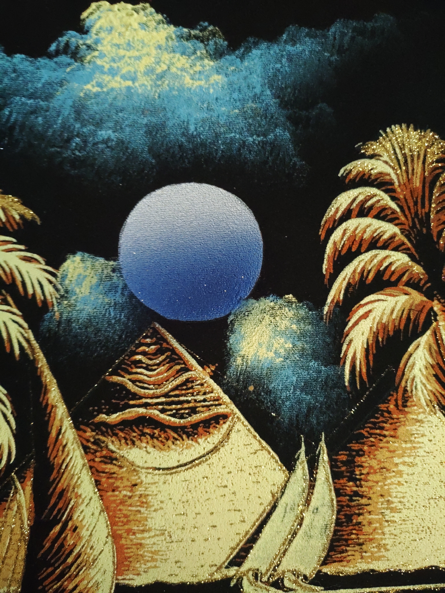 The image depicts a night scene with stylized pyramids, palm trees, and boats under a blue and gold textured sky with a prominent blue orb resembling the moon. The scene is rendered with gold glitter accents on a black background. The location, Боровково, Russia, is not discernible from the image itself.