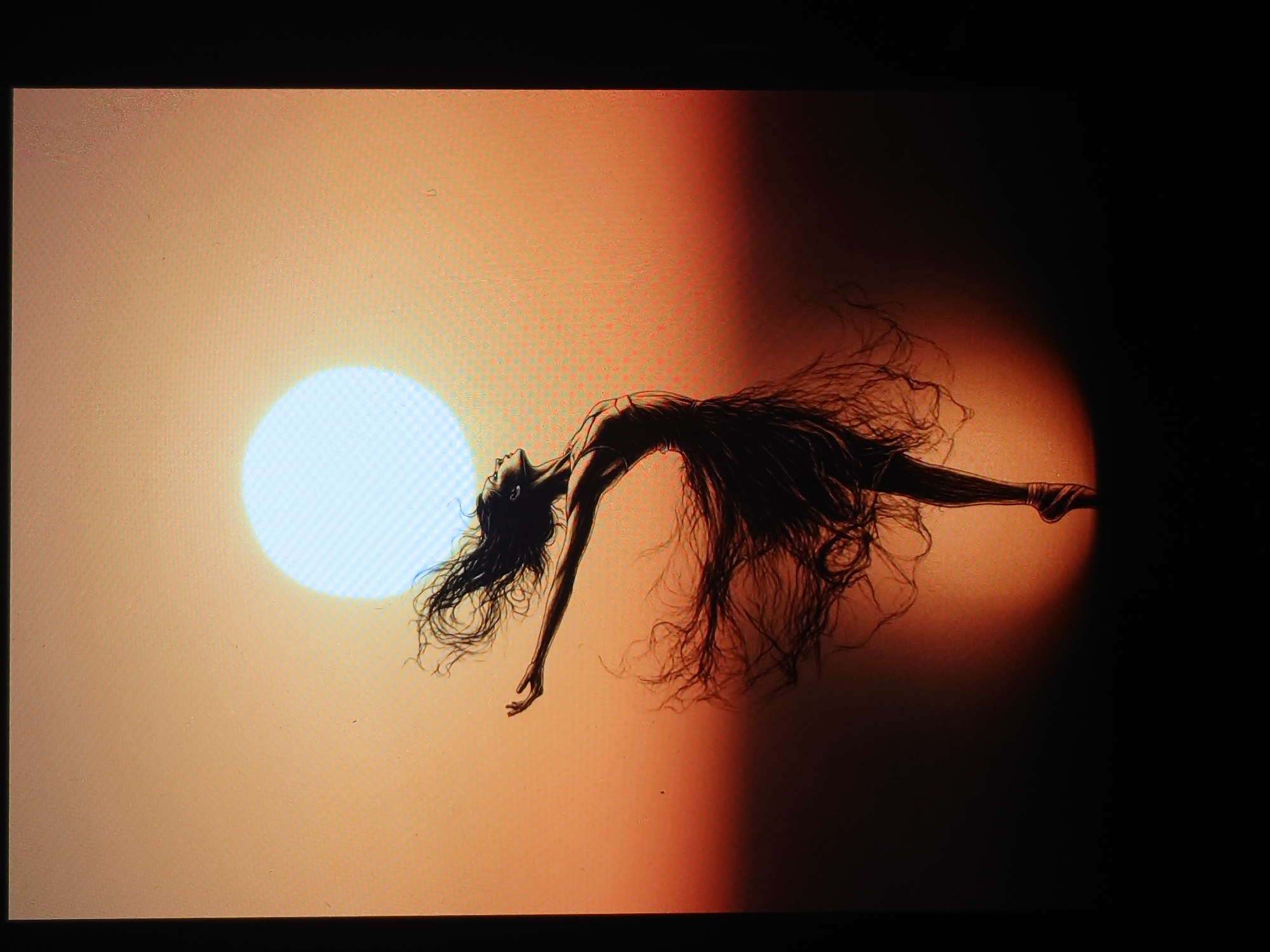 This is a digital illustration of a ballerina in a dramatic pose. She is positioned in the center of the frame, facing left with her arms outstretched and her head tilted back, looking upwards. Her hair is long and appears to be flowing in the wind, blending into her dress which is depicted as ethereal and wispy. She is wearing ballet shoes and is en pointe. The background is a gradient of warm colors, transitioning from a light peach at the top to a deep orange-red at the bottom. A large, soft, pale blue circle, suggesting a sun or moon, is prominent in the upper portion of the background. The lower portion of the image fades into darkness, with a soft spotlight effect illuminating the ballerina's legs and feet. There is no visible connection to the city of Belorechensk, Russia, or any urban elements.