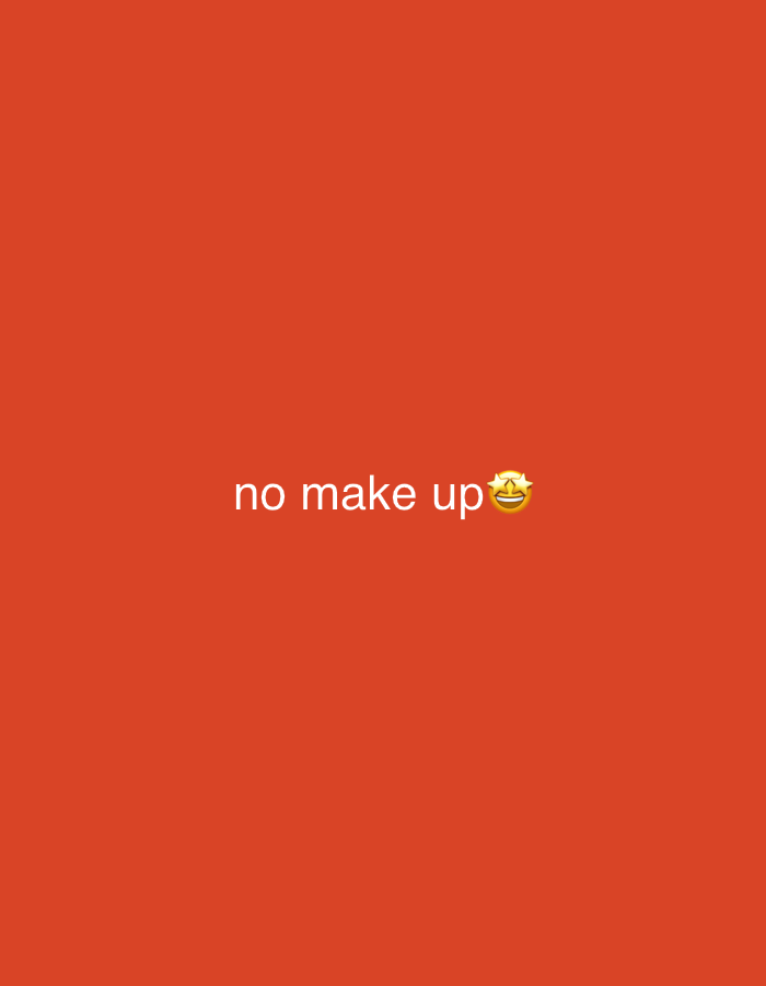 The image displays the text "no make up" in white, sans-serif font against a solid, vibrant orange background. To the right of the text, there is a yellow emoji depicting a face with stars for eyes and an open mouth, indicating excitement or joy. The background is a uniform, untextured color, suggesting a simple graphic or overlay. There are no other visible subjects, objects, or scene elements. The image does not provide any clues about the time of day, weather, or specific location, other than the general context of Perushtitsa, Bulgaria, which is not visually represented in the image itself. The activity taking place is the presentation of text and an emoji. The prominent emotion conveyed by the emoji is happiness or playful enthusiasm.