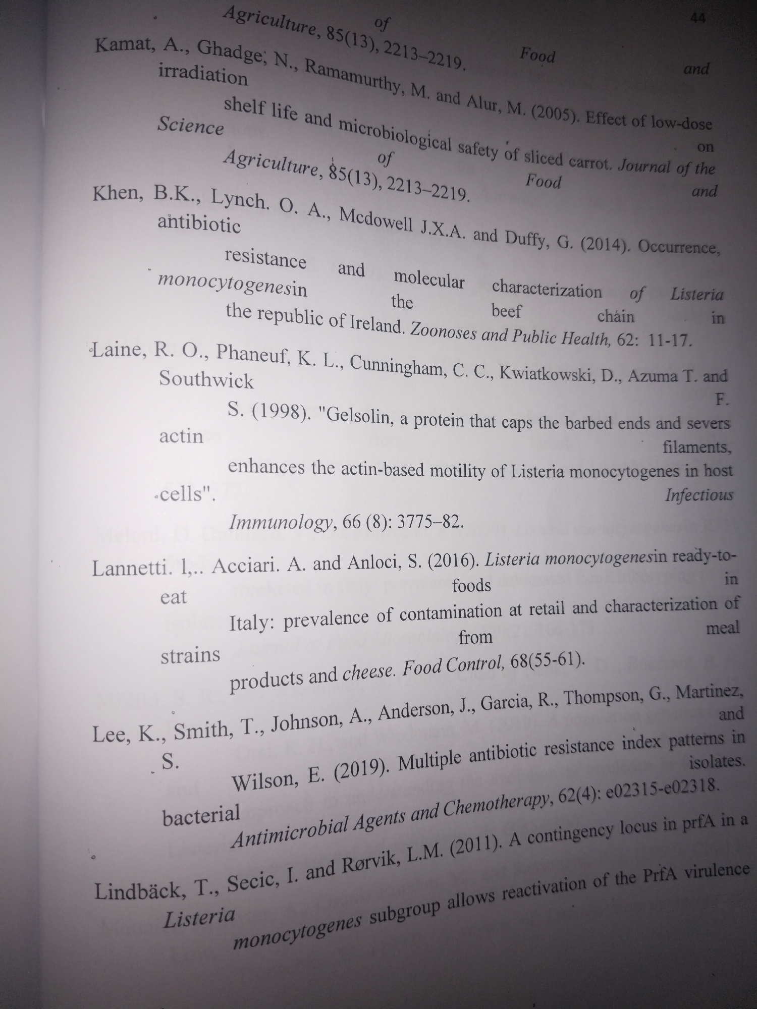 The image contains a snippet of text from a book or journal, likely a bibliography or list of references. The text appears to be academic in nature, with titles and author names in English. There is no visible information within the image that would indicate a location in the city of Uyo, Nigeria. The content focuses on scientific research, possibly related to agriculture, food science, or microbiology, as indicated by terms such as "Agriculture," "Food," "irradiation," "microbiological safety," "Listeria," "antibiotic resistance," and "Antimicrobial Agents and Chemotherapy." The text is printed on white paper and appears to be a section from a printed publication.