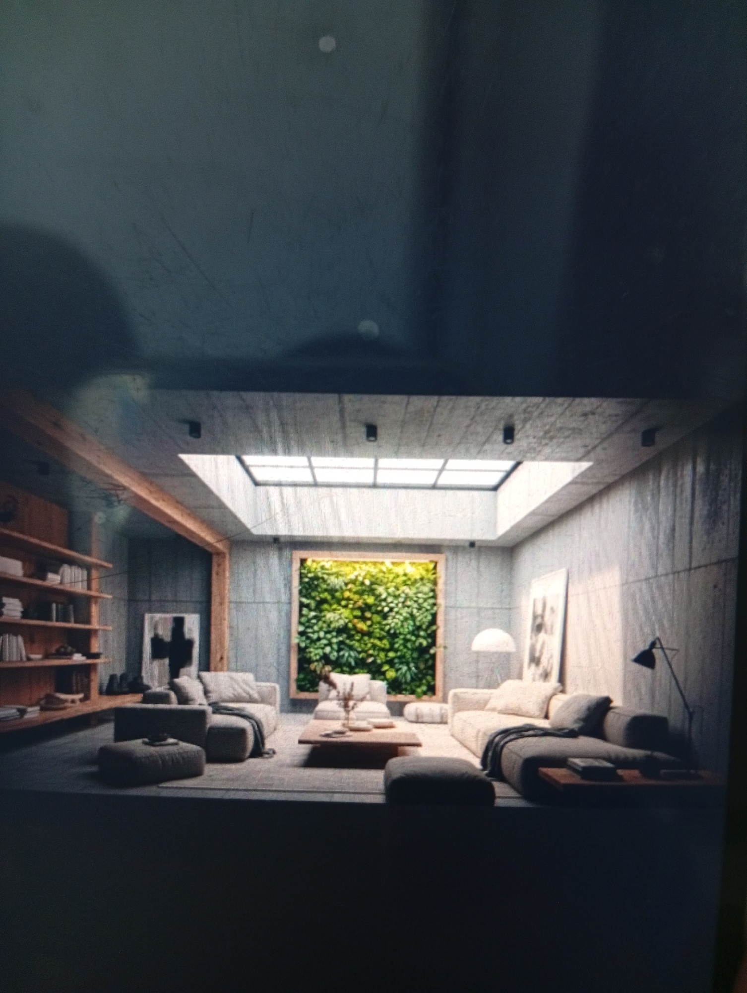 The image depicts an interior space, a living room, likely of a modern design. The walls are bare concrete. There's a large, rectangular skylight illuminating the room. A wall-mounted vertical garden with lush greenery is a prominent feature. Furniture includes two sofas, a coffee table, and poufs. There's a bookshelf on one wall, and artwork on others. One sofa has a floor lamp next to it. The image suggests a calm, indoor environment. The location is unknown, and not necessarily in Dutsen Alhaji, Nigeria. No people are visible.