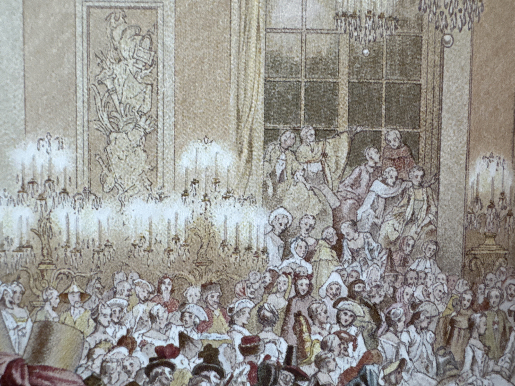 A scene depicting a large crowd gathered indoors, seemingly at a formal event or ball. Individuals are dressed in attire resembling historical European fashion, including elaborate hats, dresses, and coats. Many appear to be watching an event or listening to someone speak. Behind the crowd, there are candelabras and architectural elements such as windows and artwork. The style of the depiction suggests an etching or engraving, possibly from the 18th or 19th century. There is no evidence indicating this scene's connection to the city of Puebla, Mexico.