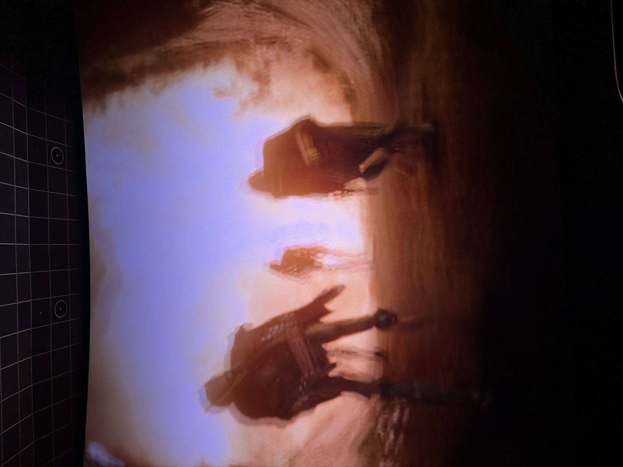 The image shows a blurred scene of people walking in what appears to be a dusty or desert-like environment. The lighting is warm, suggesting either sunrise or sunset. The individuals are indistinct, but their silhouettes suggest they are carrying packs or equipment. The location is not discernable from the image; there are no features to indicate the city of Plovdiv, Bulgaria. The photograph seems to have been taken with a long exposure or with camera shake.