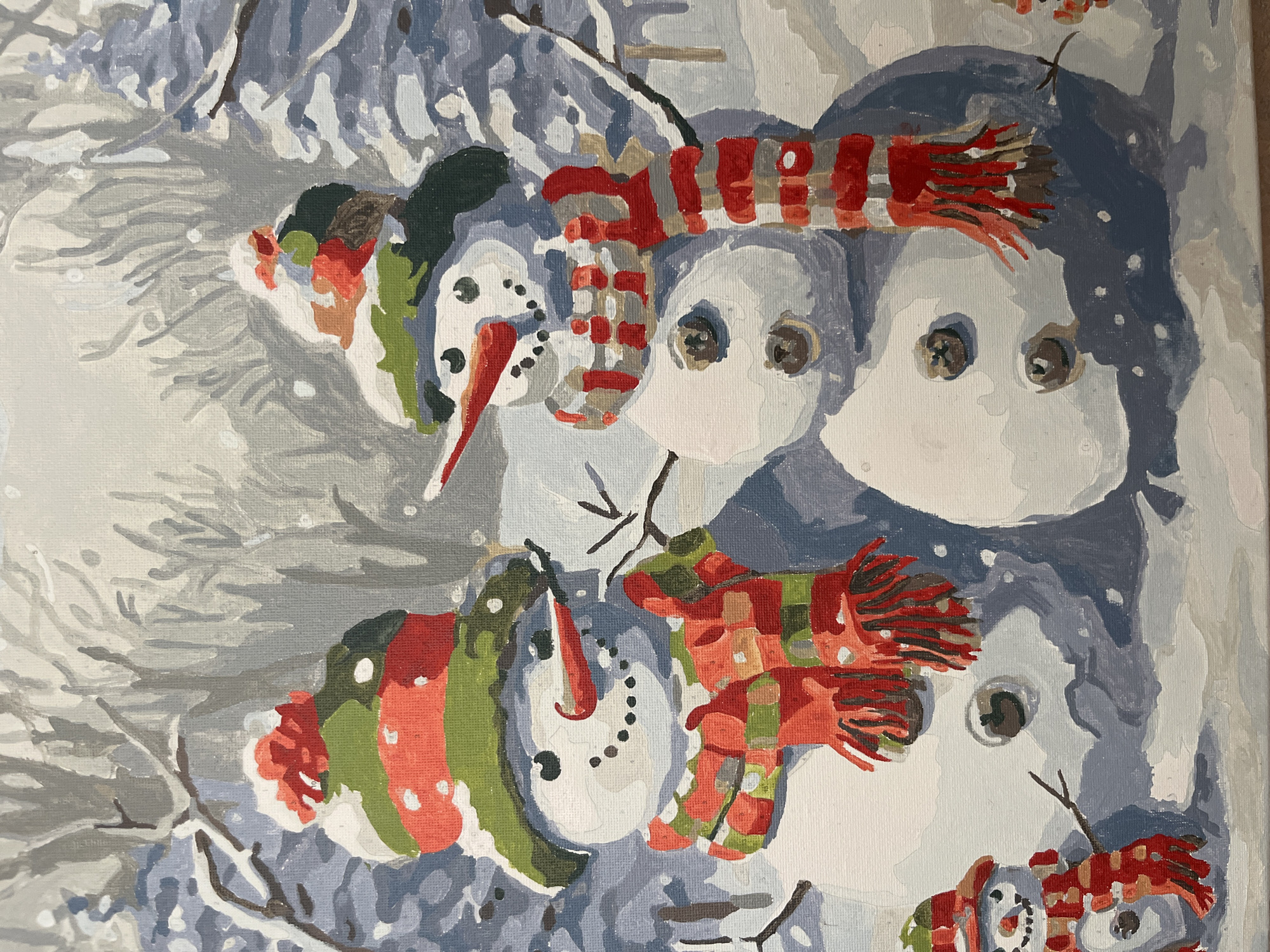 The image is a painting depicting a winter scene with snowmen. Two large snowmen stand in the foreground, facing each other. Both are wearing striped hats and scarves, with carrot noses and button eyes. The snowman on the left has a green and red striped hat with a red pom-pom, and a red and green striped scarf. The snowman on the right wears a similar hat and a red and white striped scarf. A smaller snowman is visible in the lower left corner, also adorned with a striped hat and scarf. In the background, bare trees are depicted against a soft, white and grey sky, suggesting a snowy environment. There is no indication of the city of Vvedenka, Ukraine, or any specific location within it.