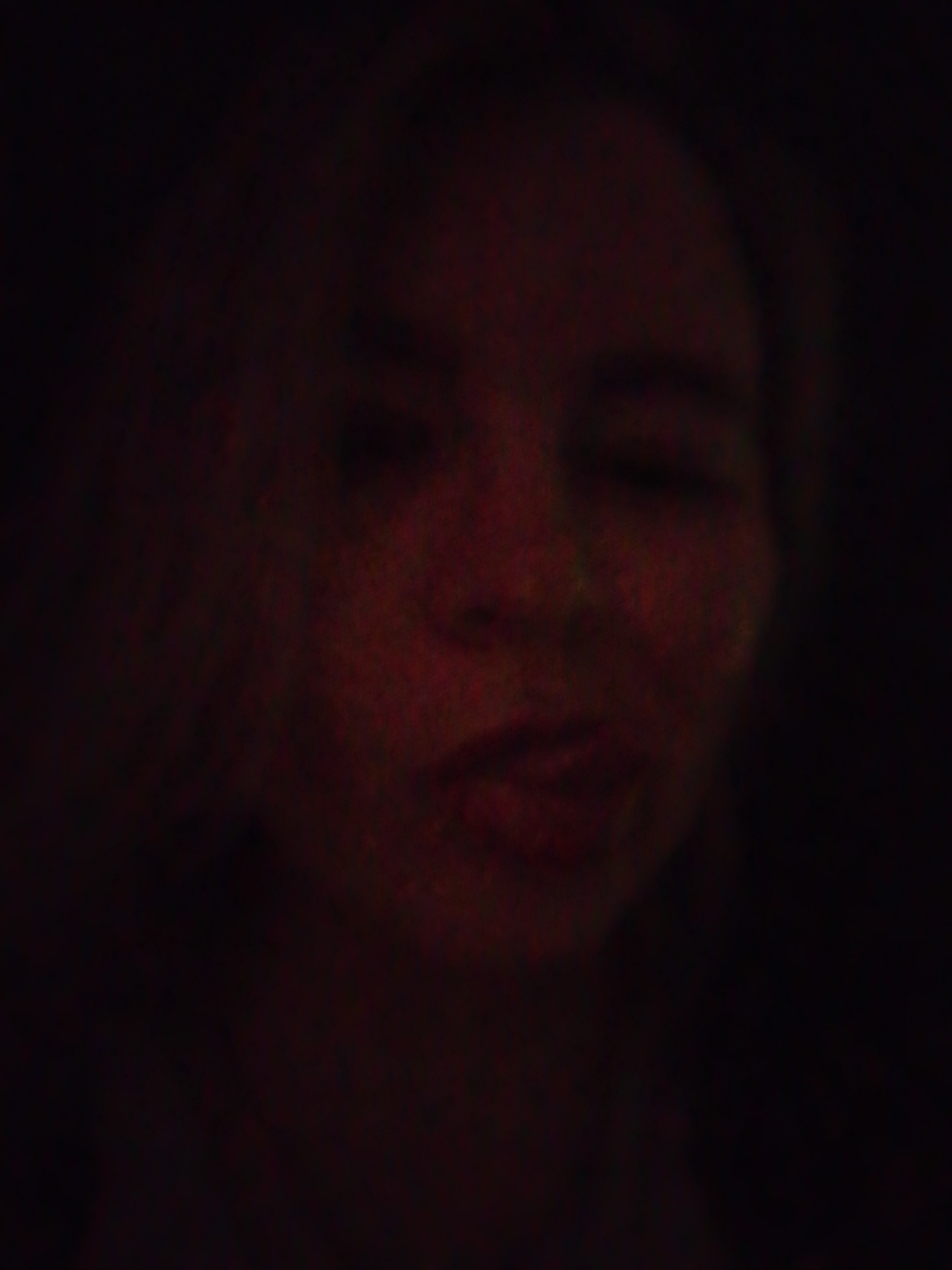 The image appears to be a dimly lit portrait of a person. Due to the poor lighting conditions, it is difficult to discern specific details. It's impossible to determine the location in the city of Izhevsk, Russia.