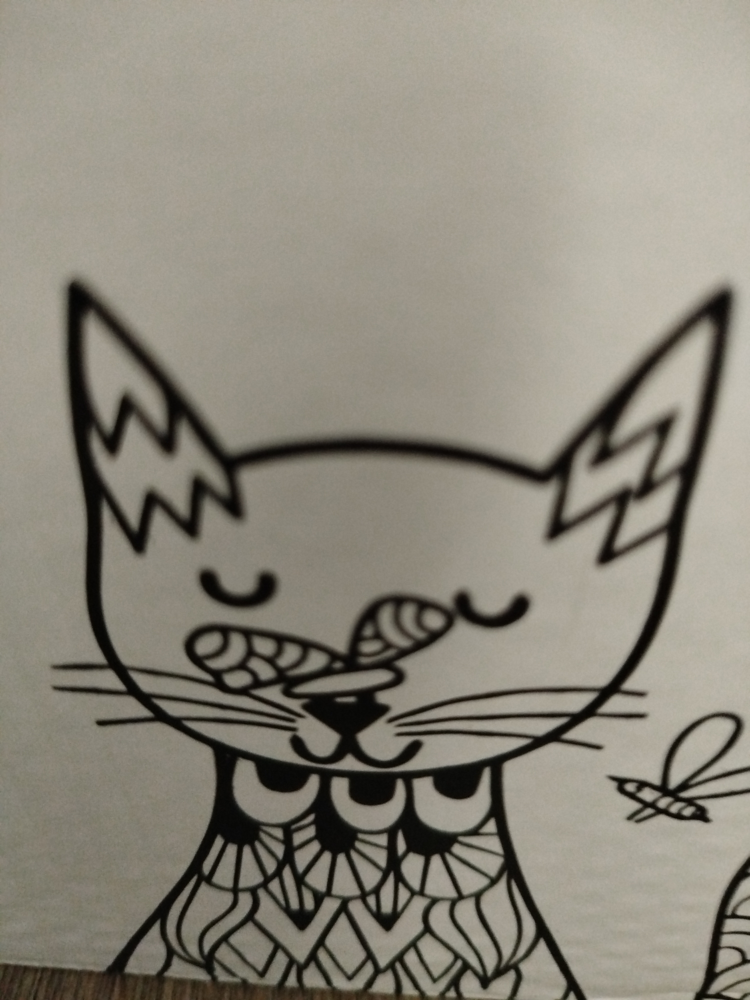 This is a black and white, close-up drawing of a stylized cat's face and upper body. The cat is facing forward with its eyes closed in a contented expression. A small insect, possibly a bee or mosquito, is drawn to the right of the cat's head. The cat's fur is detailed with intricate patterns, and its ears are pointed with zigzag markings. The drawing is on a light-colored surface, possibly paper. There is no discernible background detail that would indicate a specific location within Крывасельскі сельскі Савет, Belarus. The image appears to be a piece of artwork, not a photograph of a real-world scene.