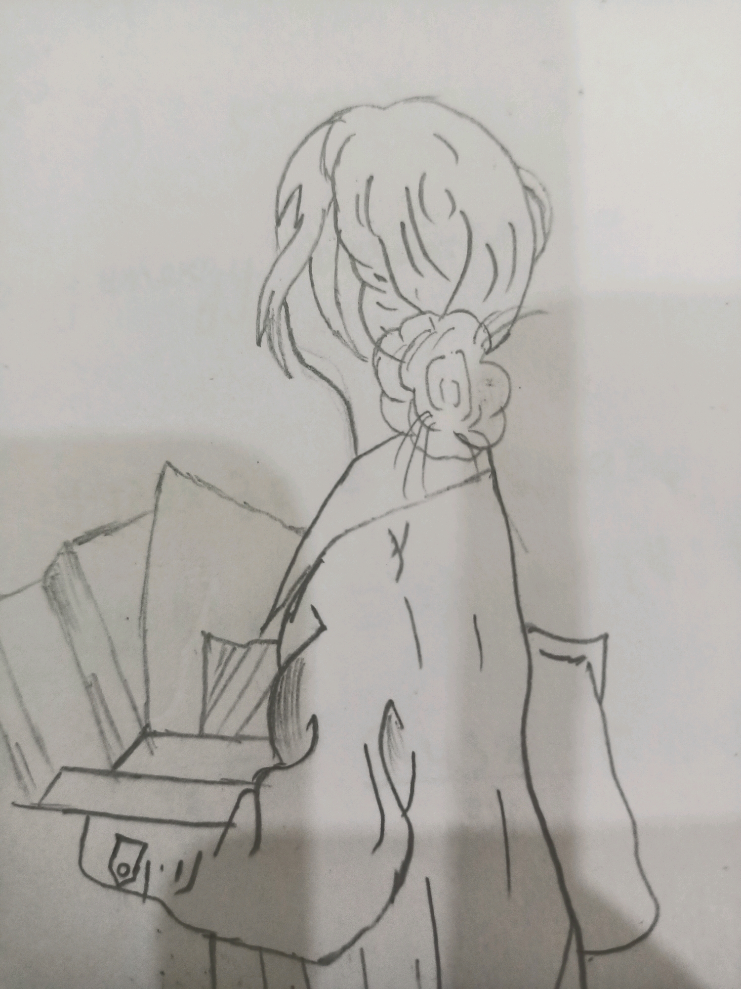 The image is a pencil sketch of a person from behind, facing away from the viewer. The subject has their hair styled in a bun with a flower-like decoration. They appear to be wearing a coat or jacket with a collar. In front of them, and held in their hands, is an open box with what look like papers or cards inside, some of which are angled upwards. The background is blank, suggesting a simple setting or a focus on the subject. The sketch is done in a loose, artistic style. There is no discernible indication of the image being located in Barrackpore, India.