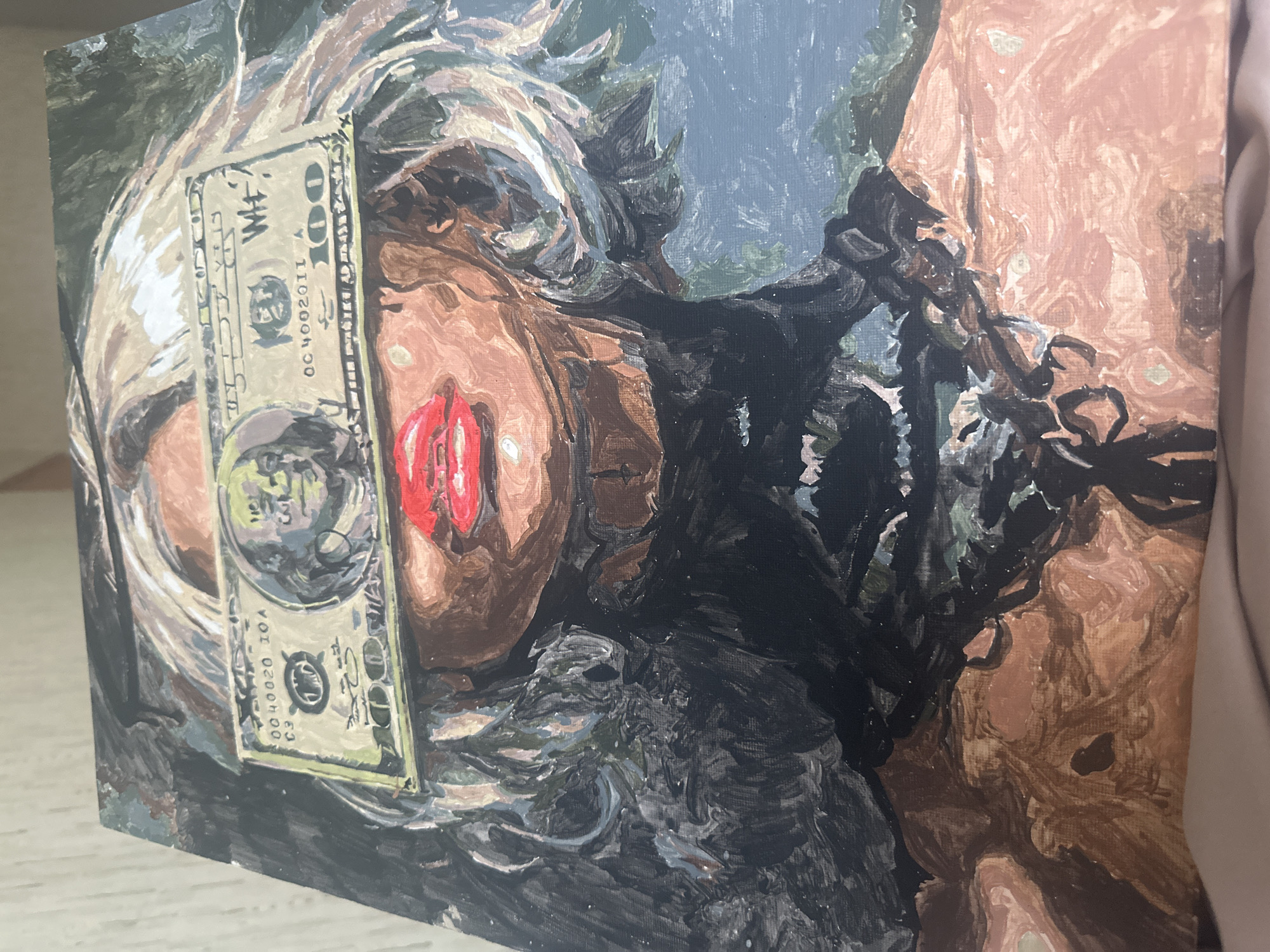 The image shows a painting on canvas, depicted at an oblique angle against a neutral background. The painting features a close-up of a person's face obscured by a one hundred U.S. dollar bill placed vertically over the nose and cheek. The person has red lipstick. The background of the painting is a mix of dark green, gray, and black hues, possibly suggesting foliage or an abstract setting. The painting is in an impressionistic style, with visible brushstrokes and a muted color palette. There is no indication of the location Высокий, Russia, within the image.