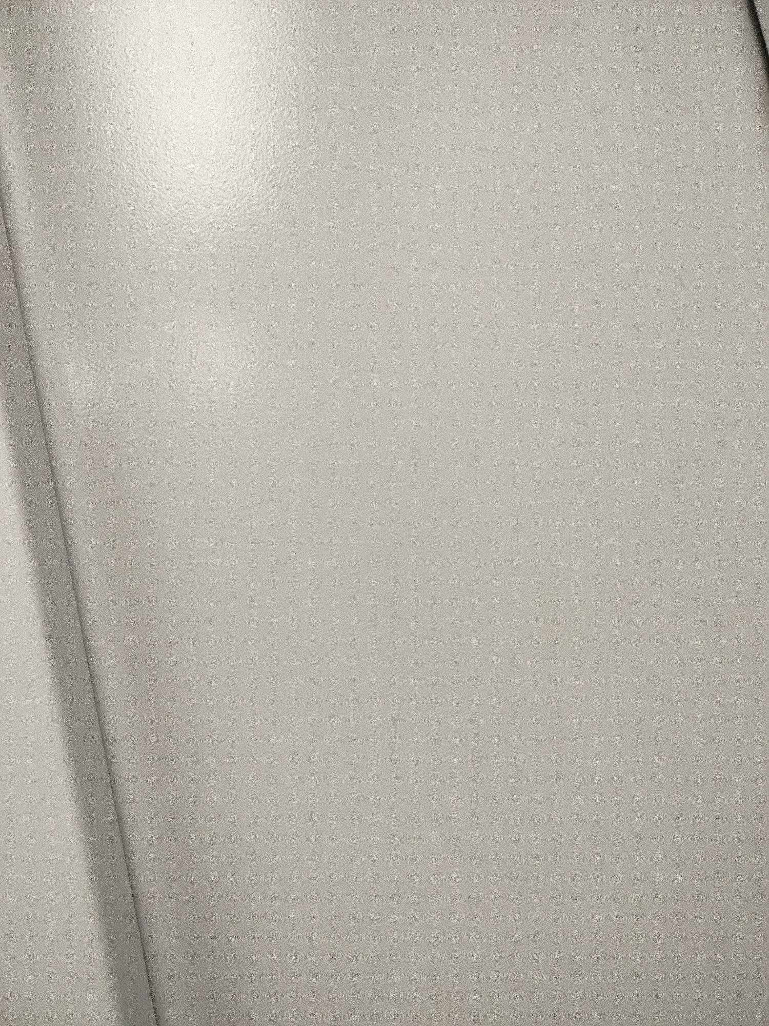 The image shows a close-up of a gray, slightly textured, possibly metallic surface. A vertical edge or corner is visible on the left side of the frame. No information within the image indicates it is located in Yerevan, Armenia, or any other specific location.
