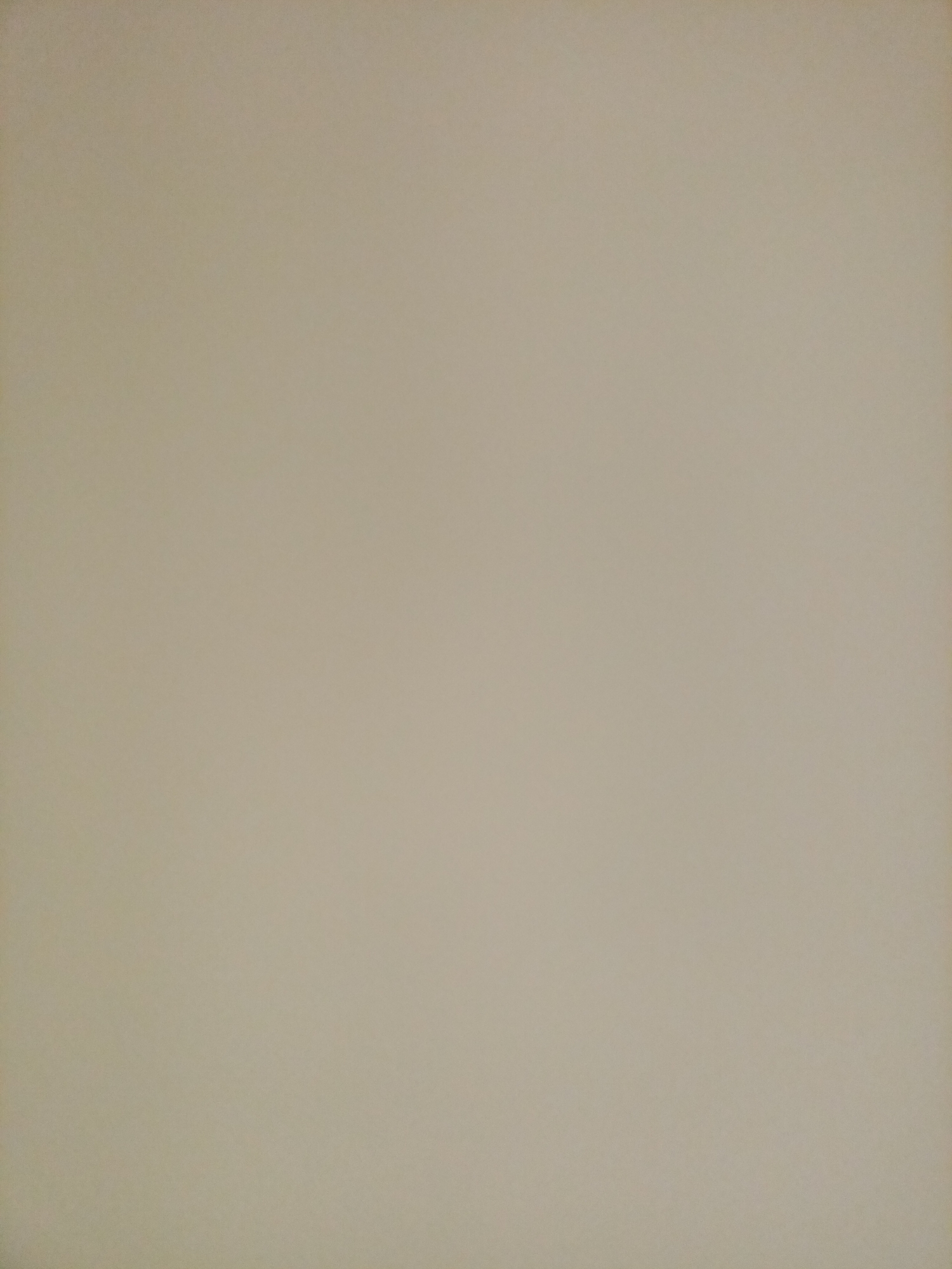 The image displays a plain, textured surface, likely a wall or a piece of paper. The color is a neutral, light beige with subtle variations in shade and tone due to lighting. There are no discernible objects, people, or distinguishing features within the frame. The image appears to be a close-up of an unadorned surface, offering no contextual clues about its location, purpose, or origin. Without any visual information to suggest otherwise, it is impossible to determine if this image is from Rostov-on-Don, Russia, or any other specific city.
