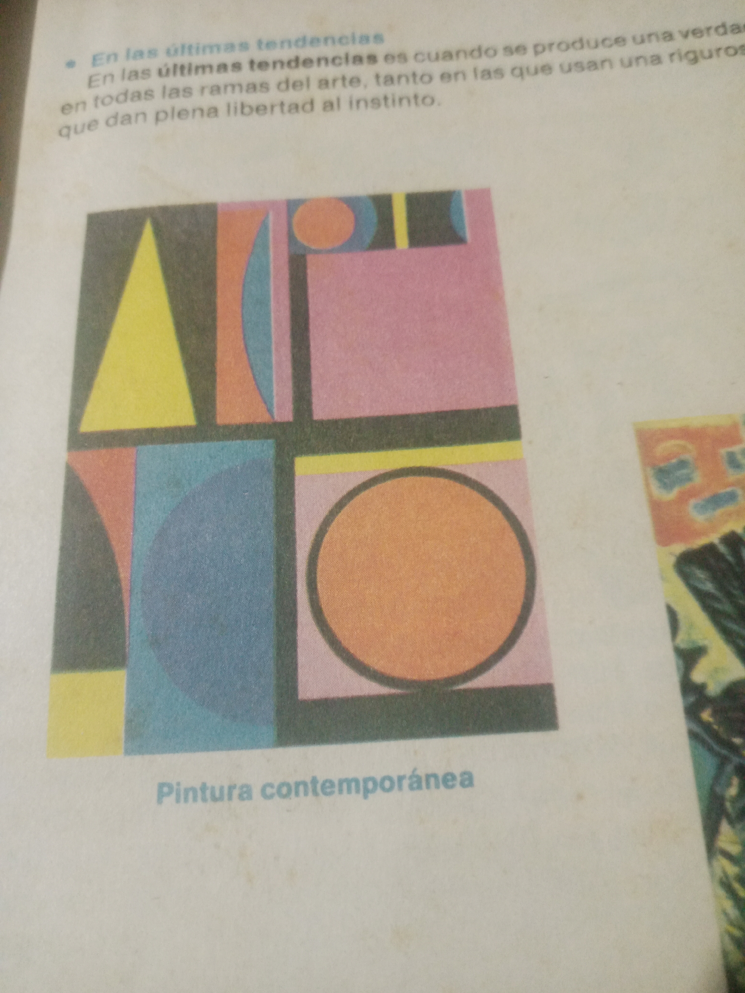 The image displays a close-up of a page from a book or magazine featuring a text passage and a colorful abstract art print. The text, written in Spanish, discusses "últimas tendencias" (latest trends) and art's freedom of expression. The art print is a geometric composition with shapes like triangles, squares, circles, and arcs in various colors including yellow, pink, blue, and orange, set against a dark background. Below the print, the words "Pintura contemporánea" (Contemporary painting) are visible. The page appears to be slightly aged and shows some wear. The image does not contain any elements that would allow for the identification of the city of Santa Ana, Venezuela, or any specific location within it.