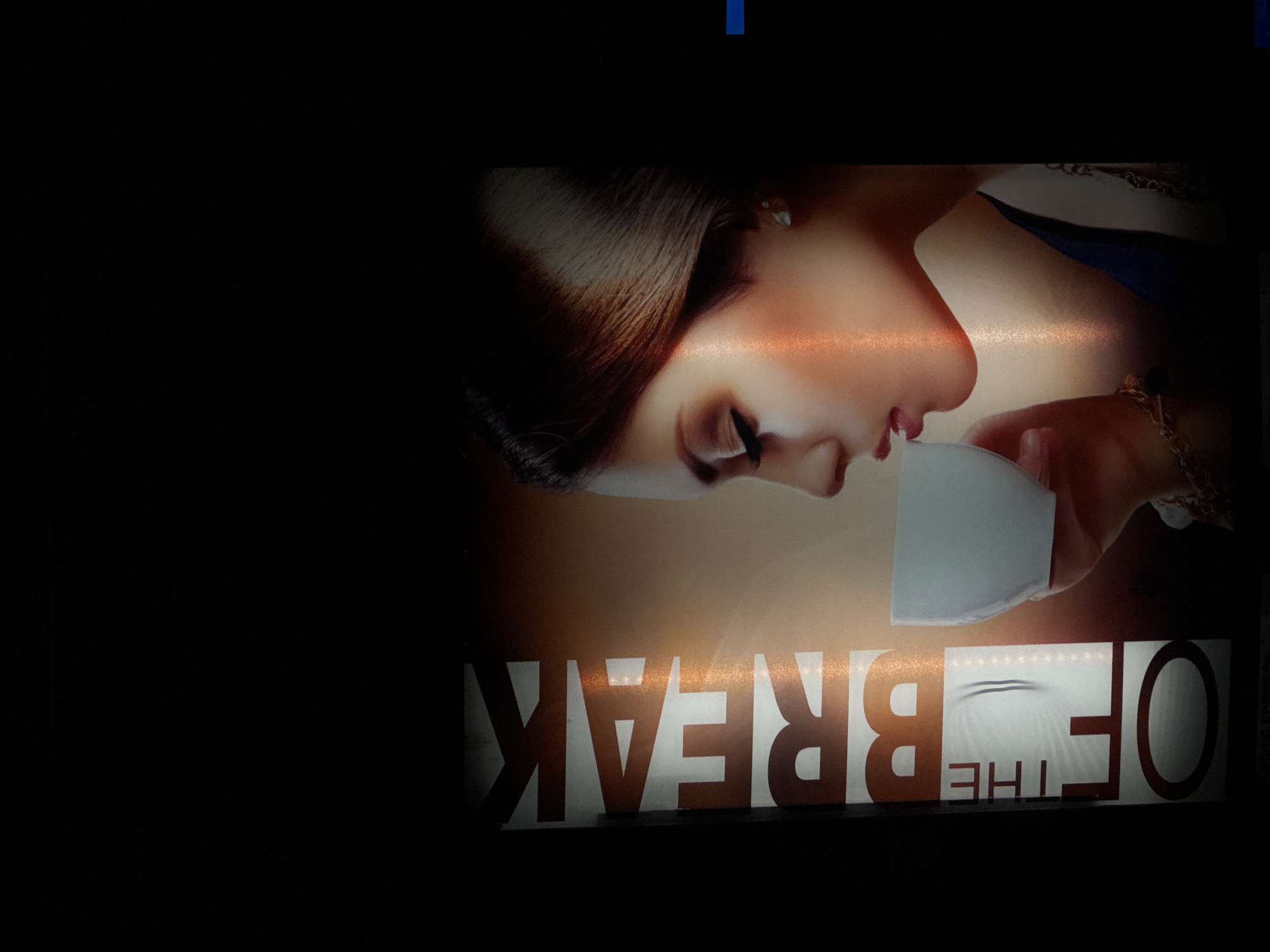 The image shows an advertisement for "The Break." The advertisement depicts a woman drinking from a white cup. The photo appears to be taken in Varna, Bulgaria.