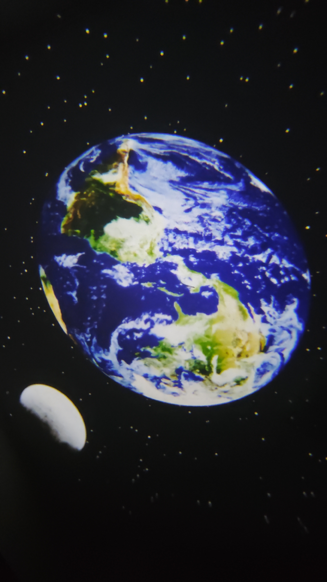 The image shows a simulated view of Earth and the Moon against a backdrop of stars. It is not possible to verify if this photograph was taken in Burgas, Bulgaria.