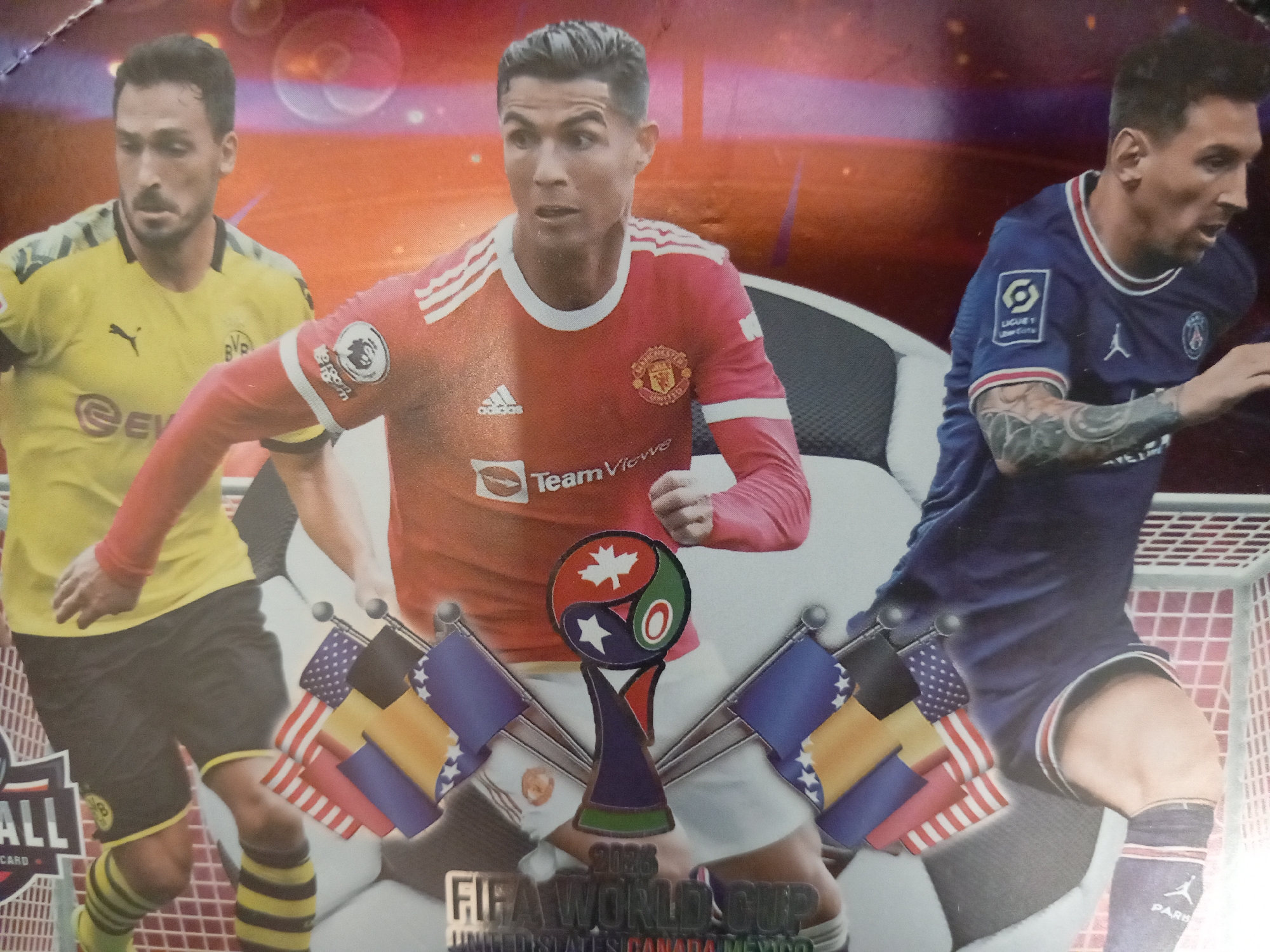 This media file is a cover that features three famous soccer players: Marco Reus, Cristiano Ronaldo, and Lionel Messi. They are depicted in action, suggesting a soccer game or event. The background is abstract, with vibrant colors and bokeh effects, creating a dynamic and energetic atmosphere. In the foreground, a trophy is prominently displayed, adorned with small flags of different countries, including the United States, Germany, and Bosnia and Herzegovina. The trophy's design incorporates elements reminiscent of a Yin Yang symbol, with a maple leaf and stars.
Visible text on the cover includes "FIFA WORLD CUP" and "2026 UNITED STATES CANADA MEXICO," clearly indicating that the cover is related to the 2026 FIFA World Cup. There are also logos of various sports brands and sponsors on the players' jerseys and the trophy itself, such as Adidas, TeamViewer, and Puma. The players are wearing their respective team kits: Marco Reus in a yellow and black Borussia Dortmund jersey, Cristiano Ronaldo in a red Manchester United jersey, and Lionel Messi in a blue Paris Saint-Germain jersey. The overall impression is one of excitement and anticipation for the upcoming World Cup.