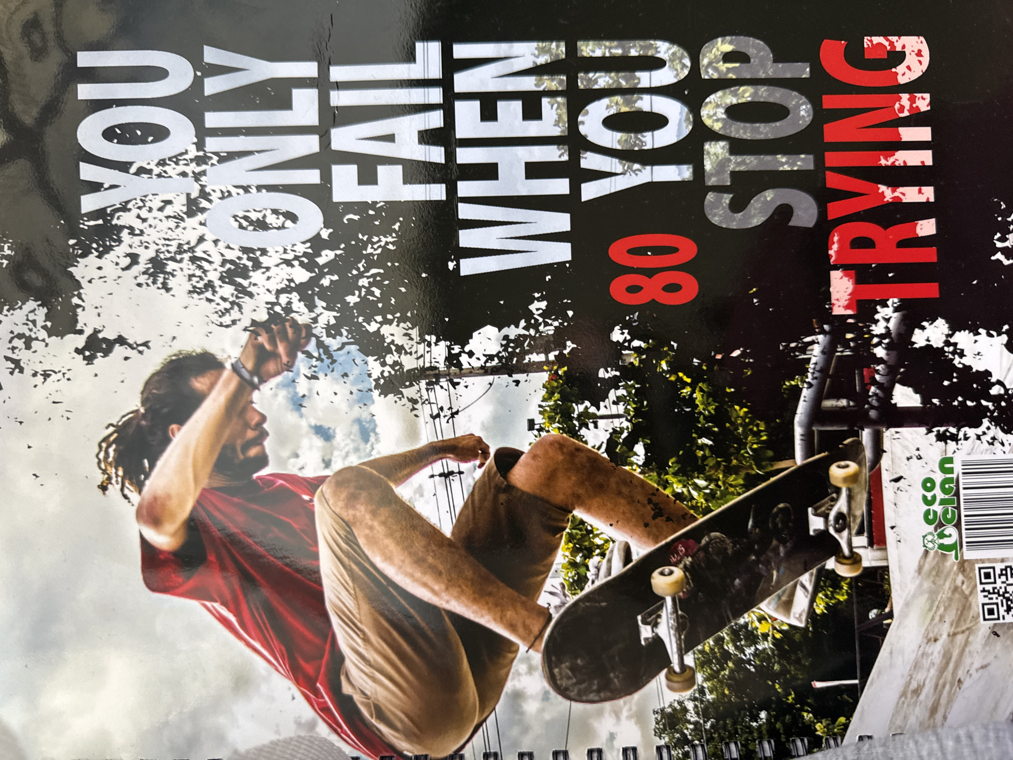 A person is skateboarding. Text on the image reads, "YOU ONLY FAIL WHEN YOU STOP TRYING." The number "80" is also visible. The location cannot be determined from the image.