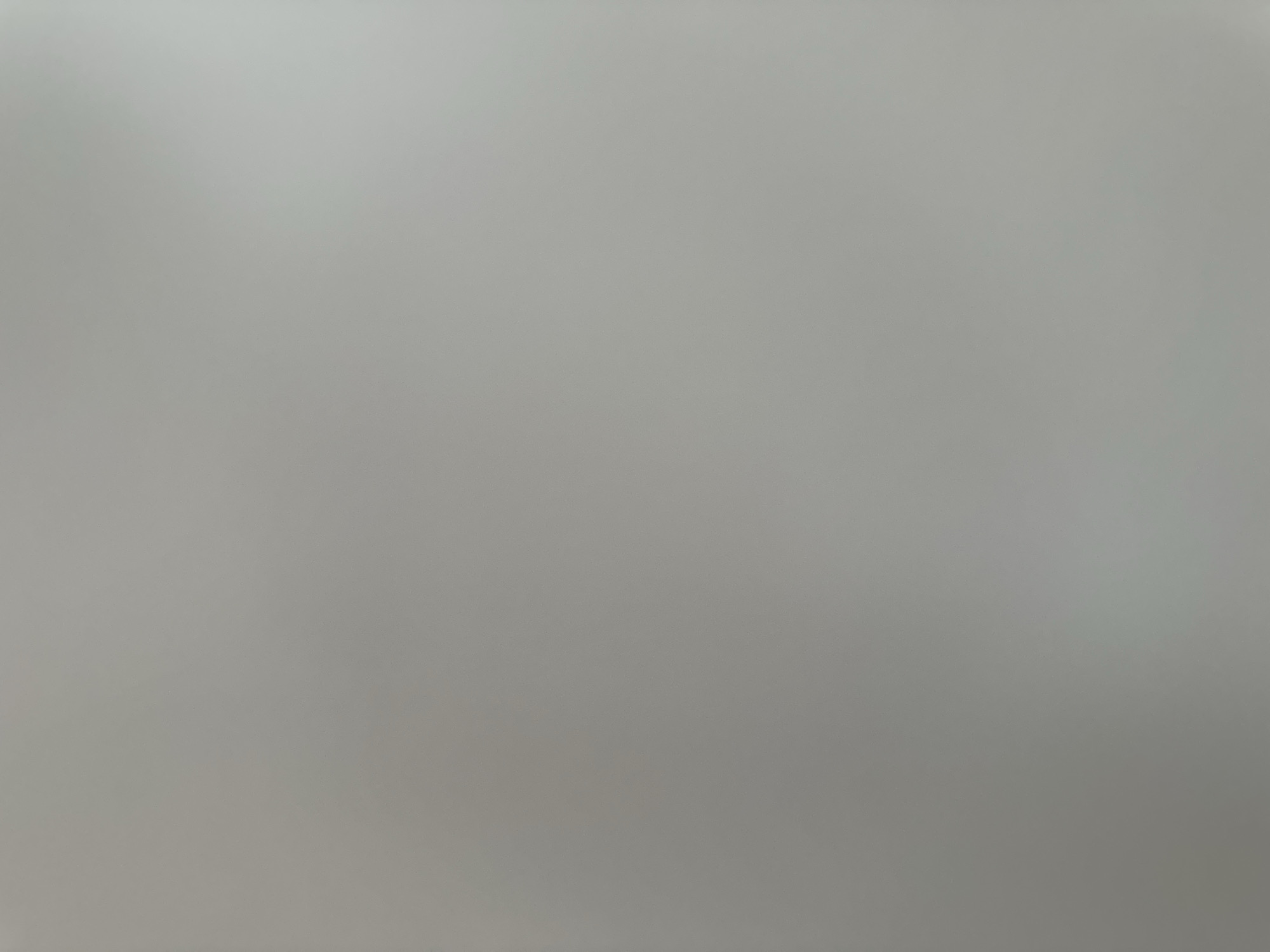 The image is a photograph of a plain, light gray surface, likely a wall or a similar flat material. There are no discernable objects, people, or any distinguishing features within the frame. The lighting appears to be even, with no strong shadows or highlights. The texture of the surface is slightly granular or matte, suggesting it could be painted plaster, concrete, or a textured wallpaper. The overall impression is one of a nondescript, neutral background. There is no visual information in the image that would allow for an identification of a specific location in Belgrade, Serbia, or any other city.