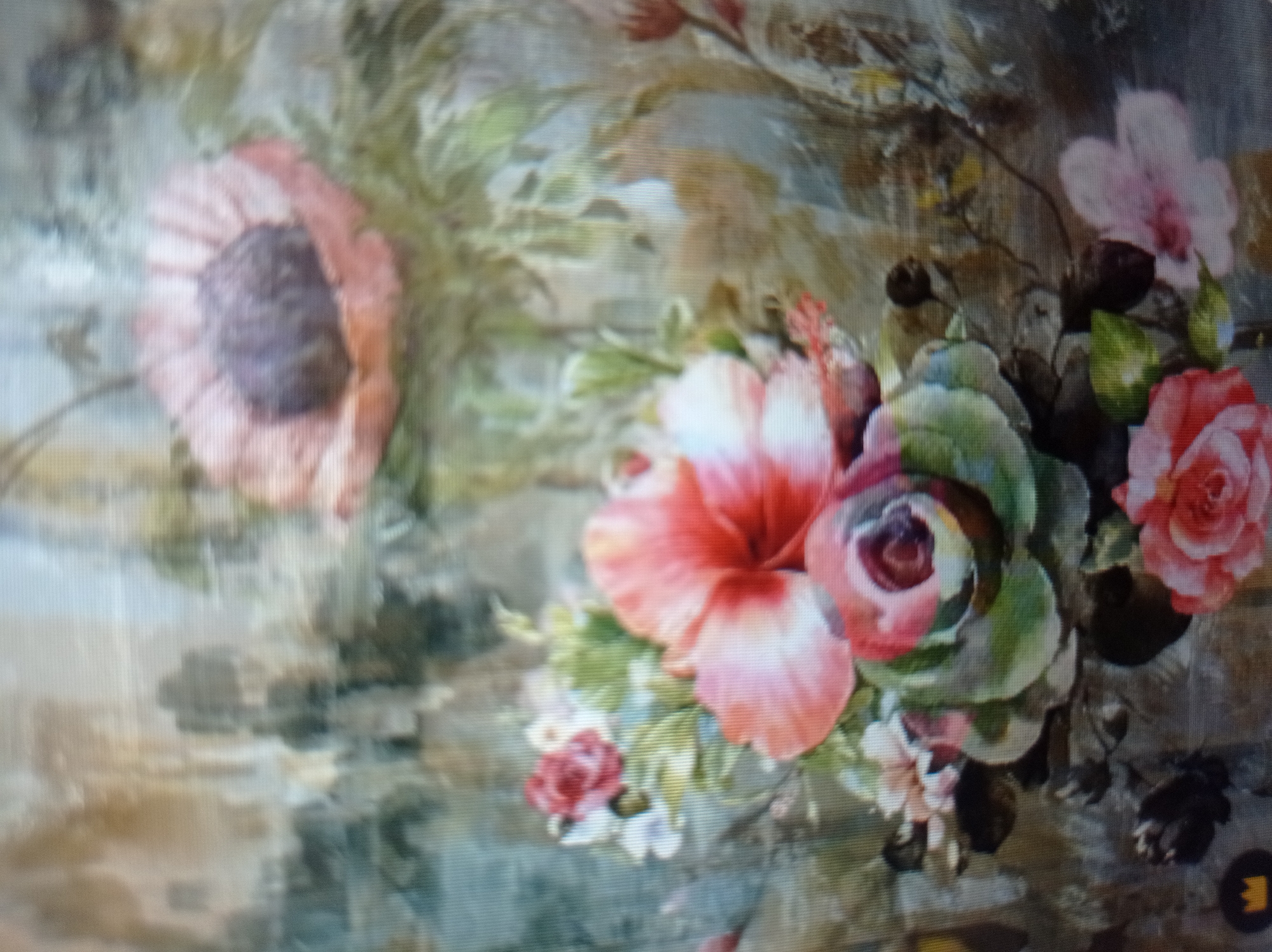 The image depicts a detailed, floral-patterned textile, possibly fabric or wallpaper, with a watercolor aesthetic. The dominant colors are muted greens, browns, and various shades of pink and peach. Several flowers are rendered in a soft, impressionistic style. In the upper portion, a large, open flower with pale pink petals and a dark center is visible. Below this, a cluster of flowers includes a prominent pink and white hibiscus-like bloom, a rose with deep red and pink hues, and a partially opened rose in the lower right. Green leaves and smaller white flowers are interspersed throughout the composition. The background is a textured blend of earthy tones, suggesting a natural or somewhat aged setting. The image quality is slightly blurred, possibly due to low resolution or the nature of the material it's printed on. There is no identifiable human presence or specific urban context within the image. Therefore, it is not possible to determine its location in Mukachevo, Ukraine, or any other specific city.