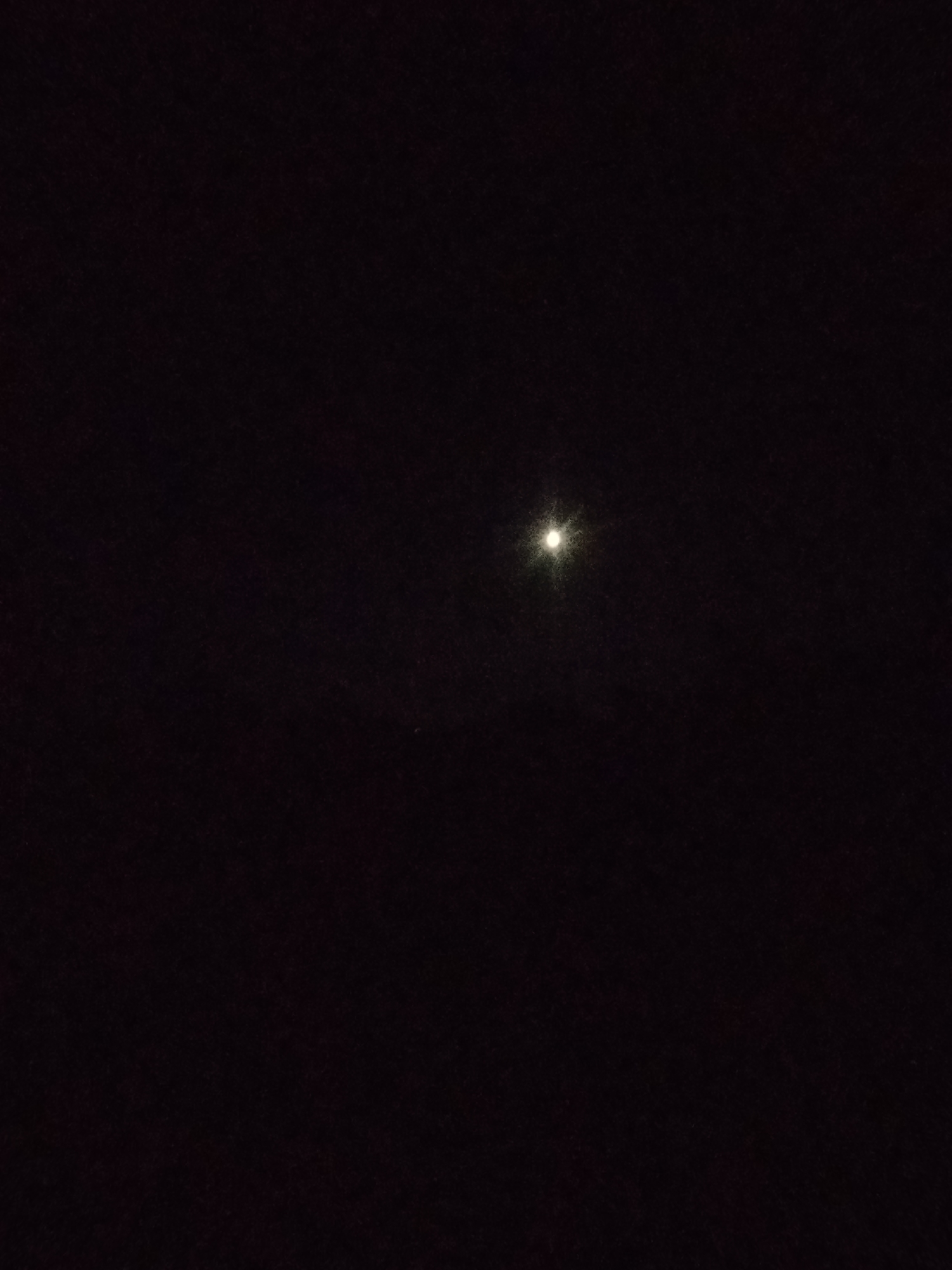 The image depicts a dark night sky with a single, bright celestial body, likely the moon, positioned slightly left of center. The sky is almost entirely black, suggesting a lack of ambient light. There are no visible buildings, landscapes, or human activity in the image. The location in Kostiantynivka, Ukraine, is not discernable from the visual information provided.