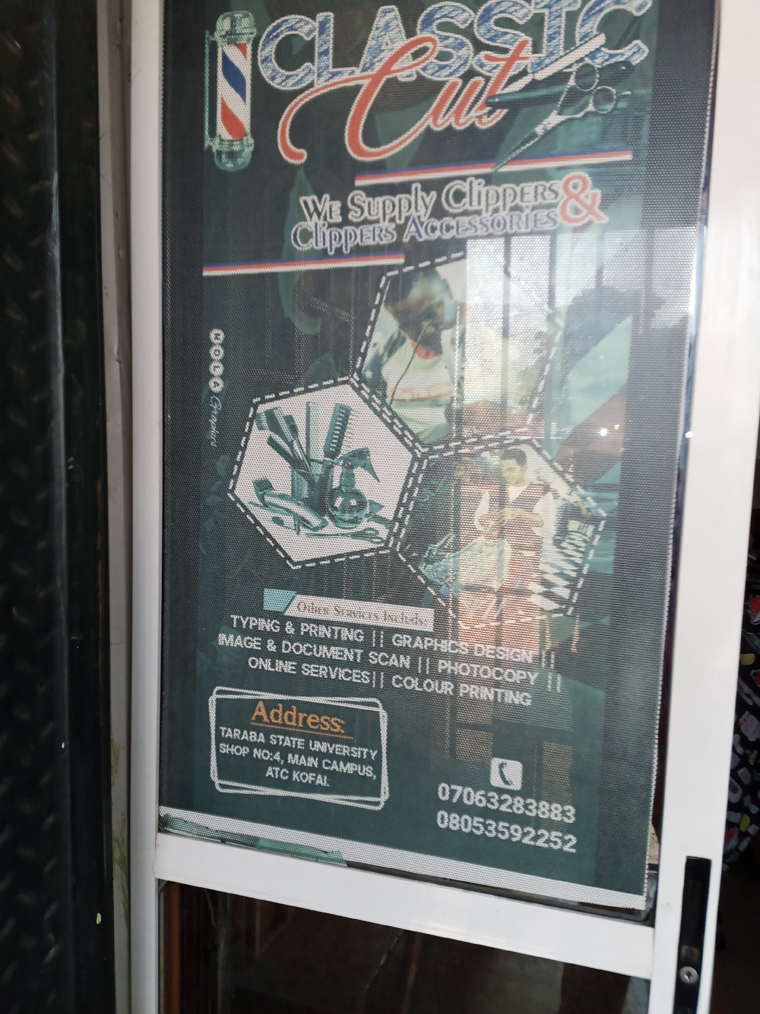 The image shows a sign for "Classic Cut" located in Jalingo, Nigeria. The sign is displayed on a glass door and advertises services related to hair clippers, accessories, typing, printing, image and document scanning, photocopy, and color printing. It also provides an address for Taraba State University, Shop No. 4, Main Campus, ATC Kofal, and two phone numbers: 07063283833 and 08053592252. The sign features a barber pole logo, scissors, and hexagonal graphics depicting barber tools and people. The overall impression is that of a commercial establishment offering a variety of services.