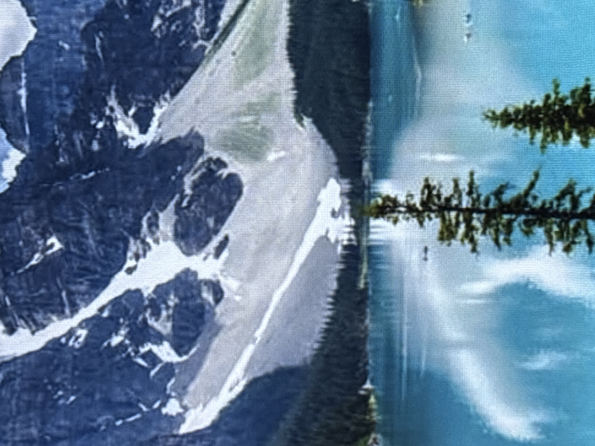 The image depicts a serene natural landscape featuring a majestic mountain range partially covered in snow, overlooking a vibrant turquoise lake. Dense evergreen trees line the shore of the lake, creating a stark contrast with the snow-capped peaks. The water's surface reflects the sky and surrounding scenery, adding to the tranquil atmosphere. A few scattered boats are visible on the lake, suggesting a recreational area. The overall impression is one of natural beauty and peacefulness. The question asks to include the city of Zvenigorod, Russia, but the image does not provide any visual cues to indicate this location. Therefore, it is impossible to confirm its presence in the scene.