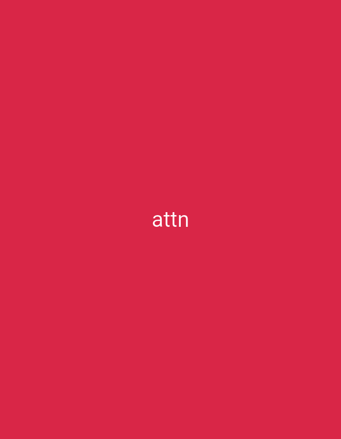 A minimalist, overhead shot shows the word "attn" in a white, sans-serif font, centered on a solid, crimson-red background. The image is a simple, stark presentation with no additional context or objects.