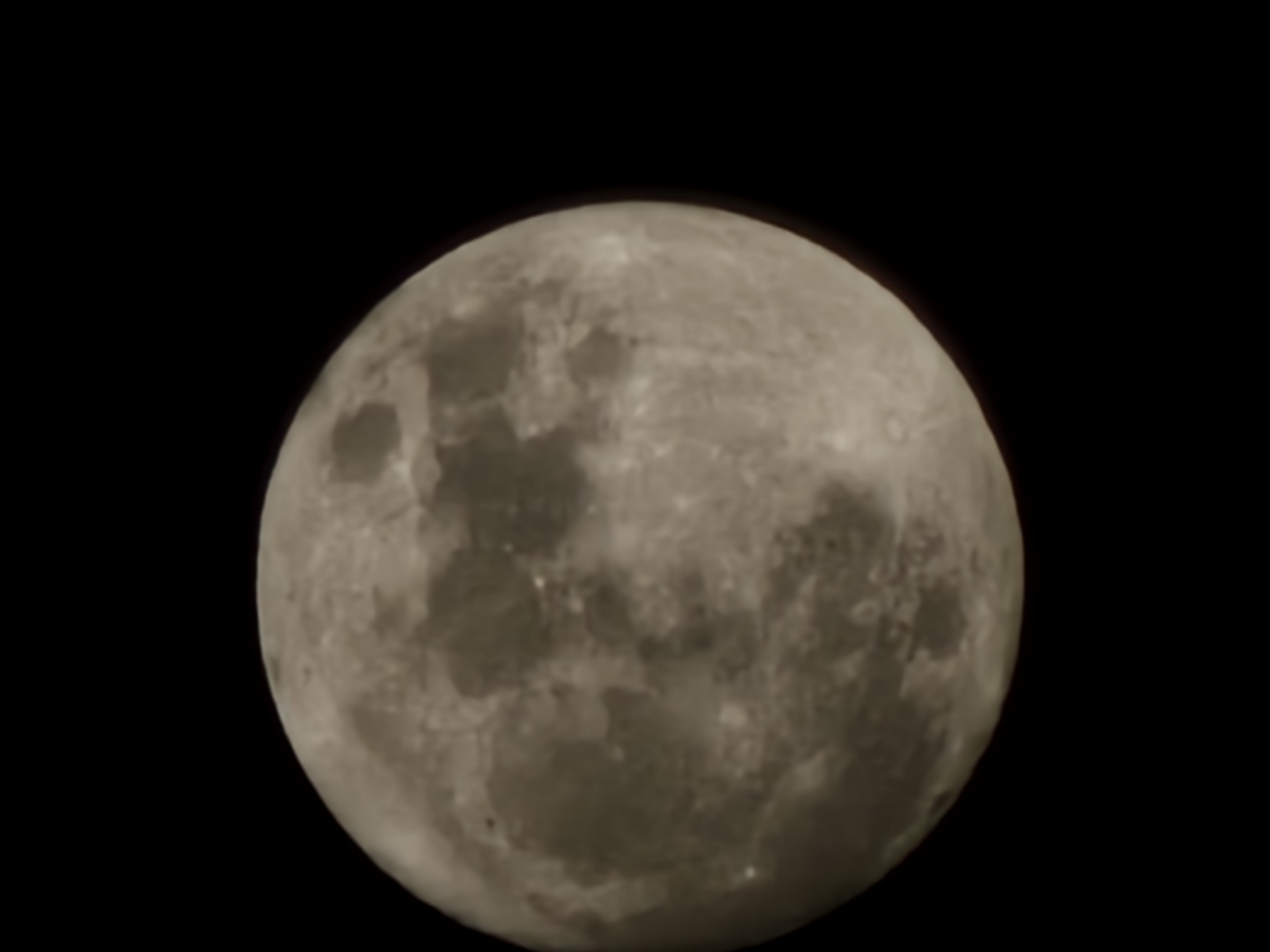 A close-up shot of the moon against a black background. Details of the moon's surface, including craters and maria, are visible. There is no information regarding the location of Holywell, United Kingdom in the image.
