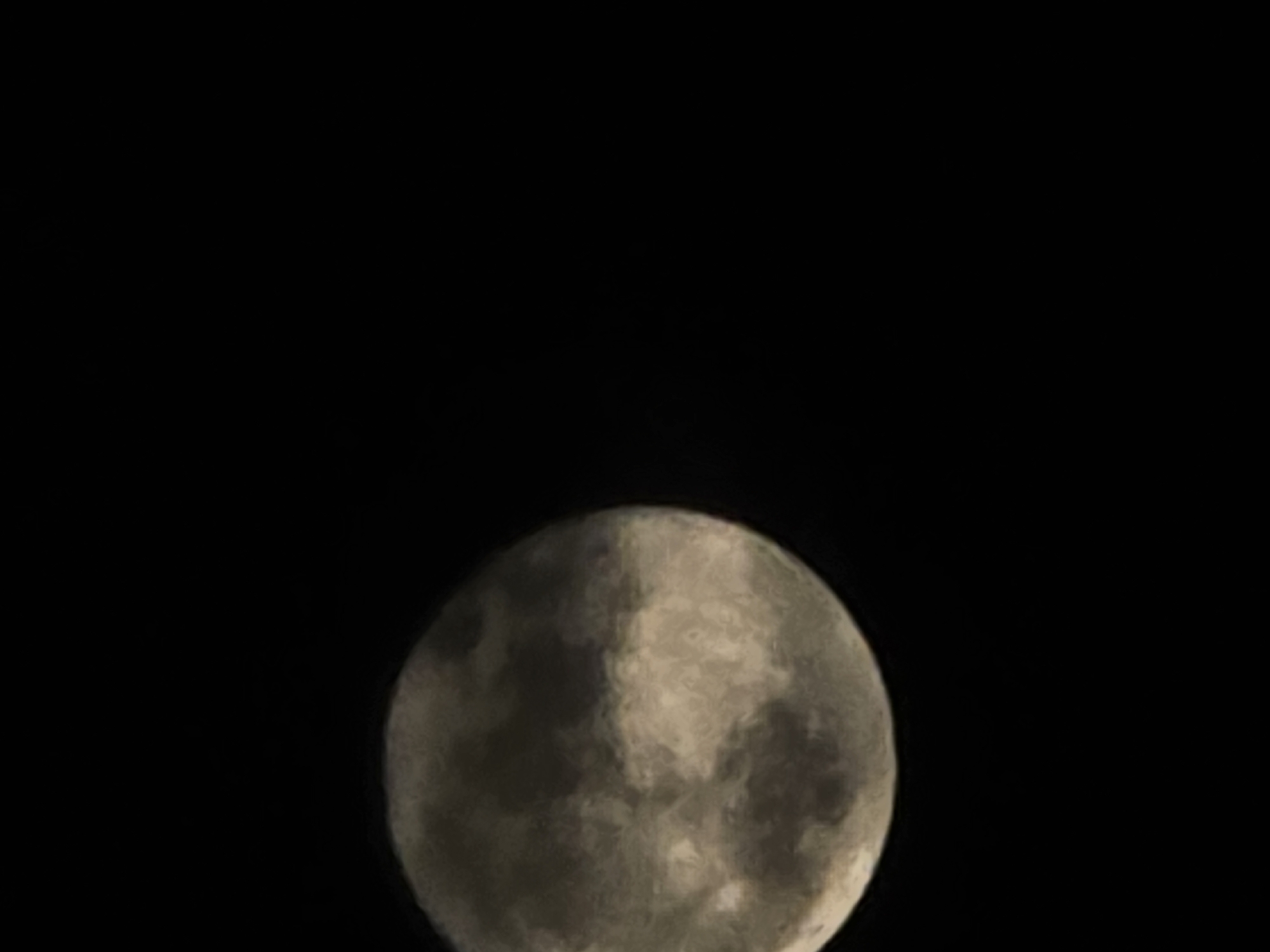 The image shows a waxing gibbous moon against a black sky. No location is indicated.
