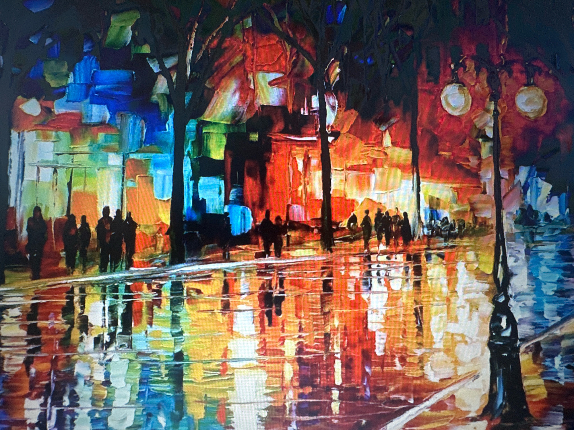 This is a digitally rendered painting depicting a night scene in Newcastle upon Tyne, United Kingdom, likely on Grey Street. The image features a street lined with buildings, their facades a mosaic of bold, abstract blocks of color in shades of blue, red, orange, green, and yellow, suggesting illuminated windows or artistic interpretations of urban architecture. In the foreground, silhouettes of trees with dark, bare branches frame the scene.
A prominent lamppost with two glowing orbs stands to the right, its dark silhouette contrasting with the vibrant background. In the middle ground, several figures are depicted as dark silhouettes, walking along the street. The wet pavement reflects the colorful lights of the buildings and figures, creating a shimmering, impressionistic effect with streaks of yellow, orange, blue, and white. The overall style is heavily textured and abstract, with thick brushstroke-like applications of color, giving the impression of a rainy night with vibrant reflections.