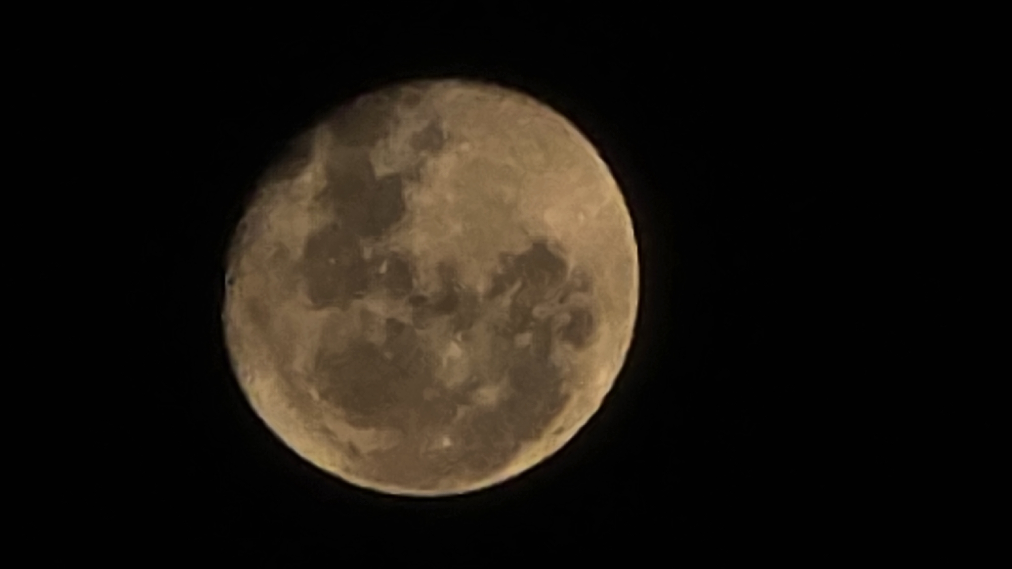 The image shows a full moon in the night sky. The moon is a golden yellow color and its surface features are visible, including craters and maria. The sky is black. It is impossible to determine the location of the image with certainty, and there is no information about the city of Sofia, Bulgaria.