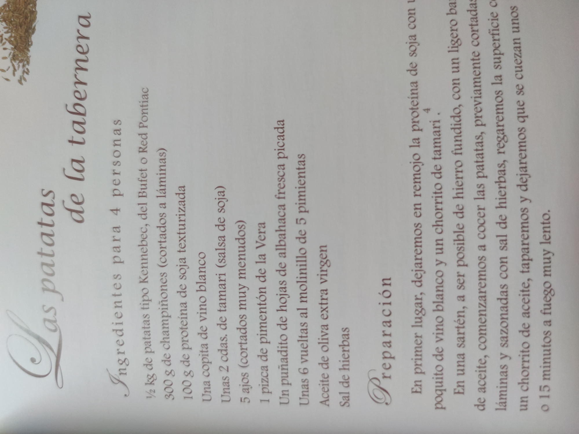 The image shows a recipe titled "Las patatas de la tabernera," which translates to "The tavern keeper's potatoes." The recipe lists ingredients for four people, including potatoes, mushrooms, textured soy protein, white wine, tamari sauce, garlic, paprika, basil, five peppercorns, olive oil, and herb salt. The preparation instructions advise soaking the soy protein, then cooking the sliced potatoes in a cast-iron skillet with olive oil and seasonings. The potatoes should be covered and cooked slowly for 10-15 minutes.