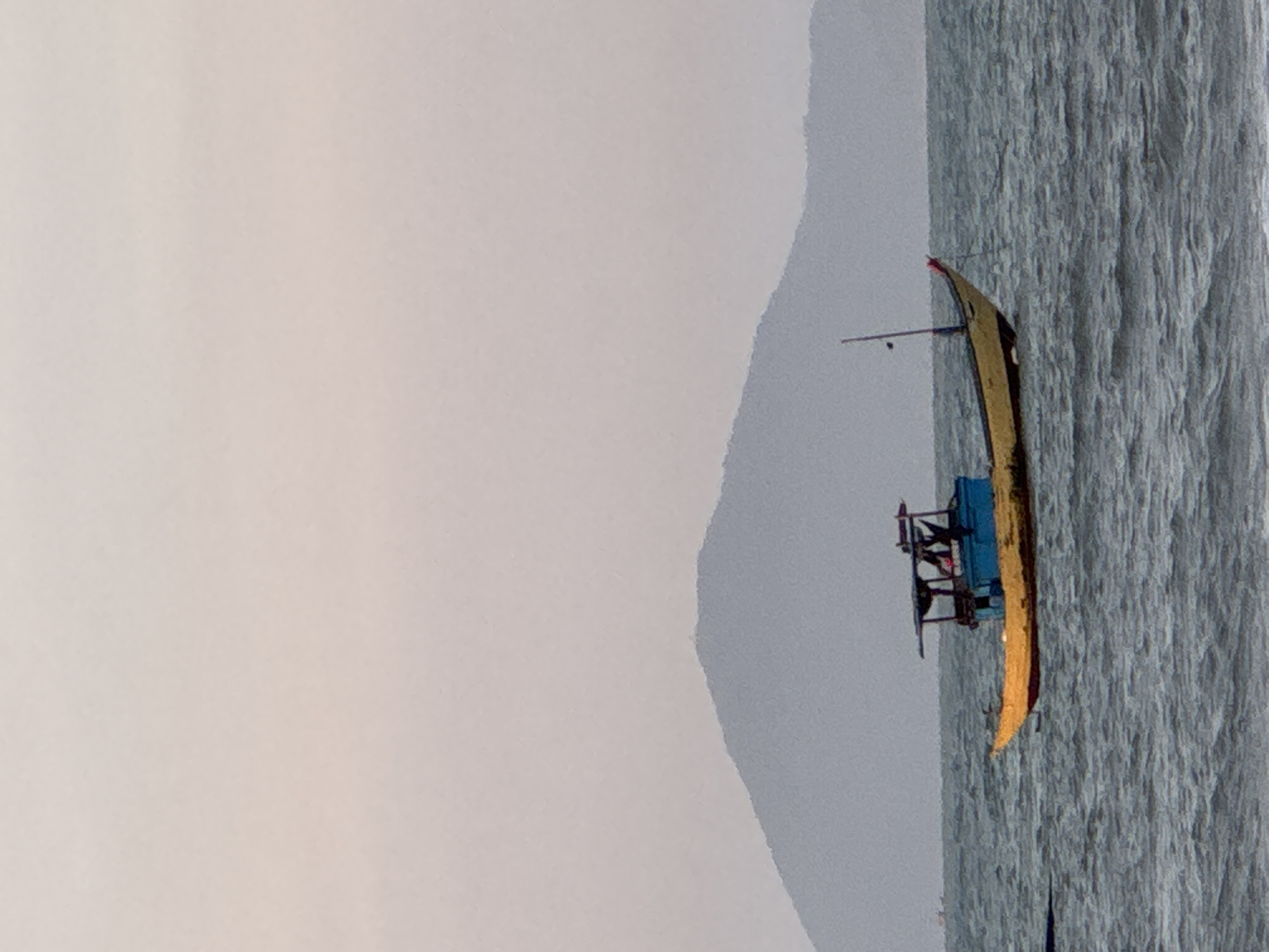 A boat is sailing in the sea near a mountain in Đà Nẵng, Vietnam.