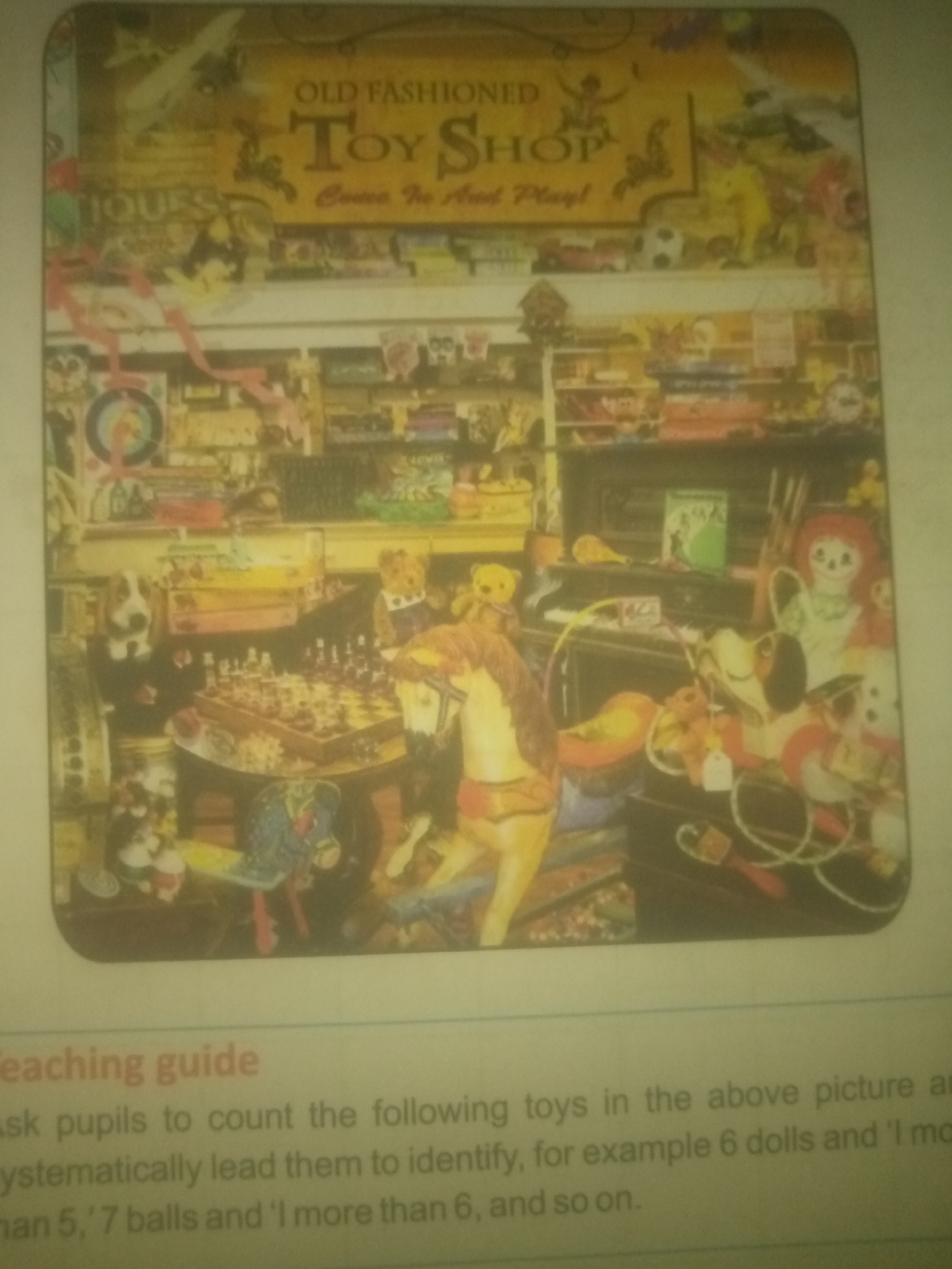 The image displays a vintage "Old Fashioned Toy Shop" scene, filled with a wide assortment of toys. Prominently featured is a large wooden rocking horse in the foreground, a chess set on a table, various stuffed animals including teddy bears and a dog, and numerous other toys stacked on shelves and displayed on surfaces. The overall impression is of a cluttered yet charming toy store. The image also includes text at the bottom labeled "Teaching guide," which suggests this is an illustration from an educational resource. There are no people visible in the image, and no discernible elements connect it to the city of Jauro Yinu, Nigeria. The scene is a still image, depicting a static display of toys within a shop.