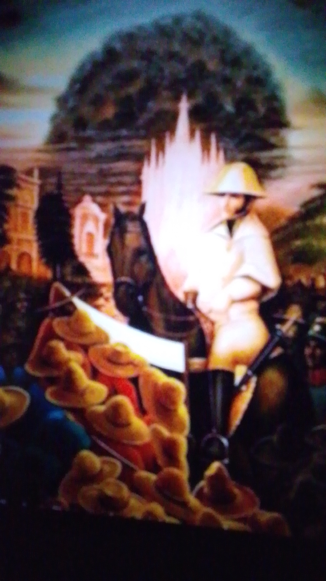 The image appears to be a painting or mural depicting a figure on horseback, possibly in a historical or ceremonial context. A person wearing a light-colored uniform and a helmet is seated on a dark horse. In front of the horse and rider, there is a pile of yellow hats. In the background, there are architectural elements that suggest buildings and a large, dark tree. A bright, possibly ethereal, structure is visible behind the rider. The overall scene is richly colored with a dramatic lighting effect. There is no discernible location information within the image or associated context to indicate it is in the city of Aznakayevo, Russia.