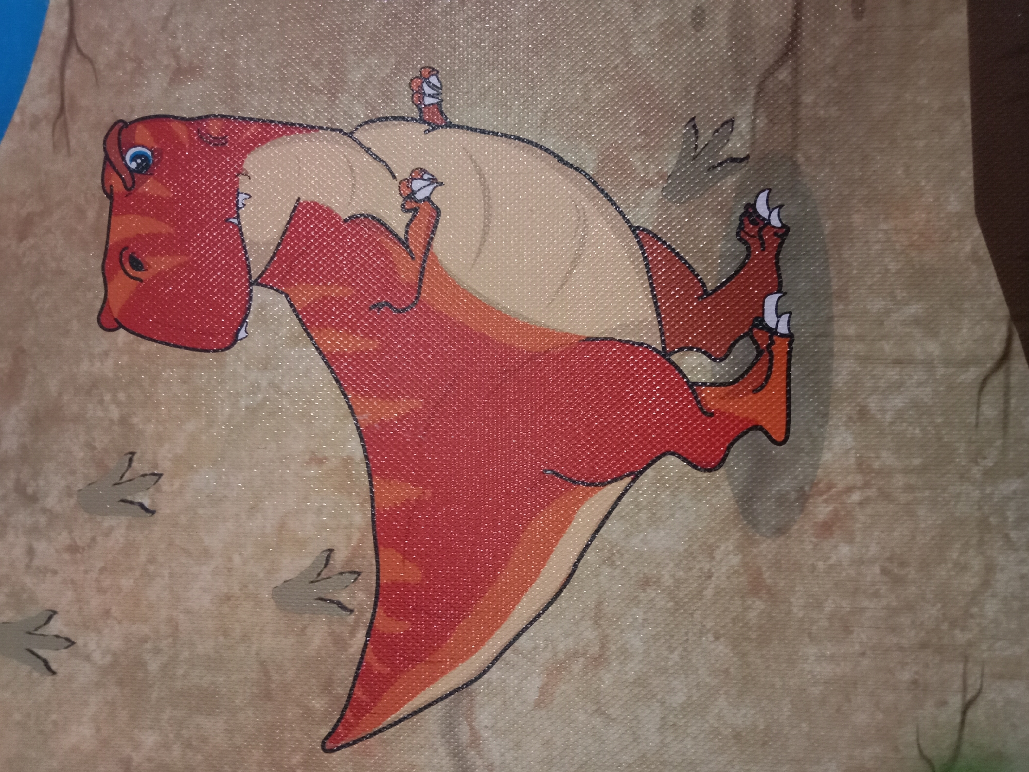 The image shows a stylized cartoon depiction of a red dinosaur with a tan belly, its body angled to the left. The dinosaur has a large head with blue eyes, sharp teeth, and a crest on its head. Its legs and feet are visible, with sharp claws. There are faint footprints on the tan background, which appears to be textured like a canvas or woven fabric. The overall impression is a playful, animated illustration. The image does not contain any elements that can be used to determine its location in Kutosari, Indonesia.