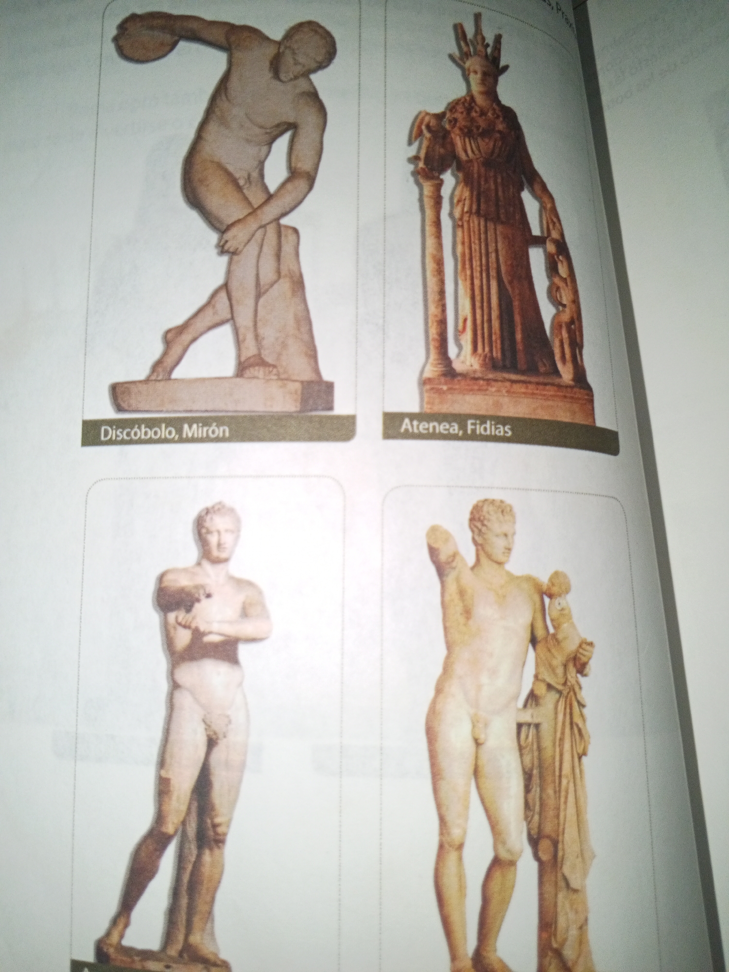 The image displays a book with four classical sculptures. The top left sculpture depicts a male athlete in motion, identified by the text "Discóbolo, Mirón" as the Discus Thrower by Myron. The top right sculpture shows a female figure wearing a headdress and holding a shield, labeled "Atenea, Fidias," suggesting it is Athena by Phidias. The bottom two sculptures are of male figures; the bottom left is a standing male nude, and the bottom right is a male figure with an object held in his left arm and leaning against a column. The background of the image is plain white, consistent with a book's page. There is no discernible information or visual element within the provided image that connects it to the city of La Tagua, Venezuela.