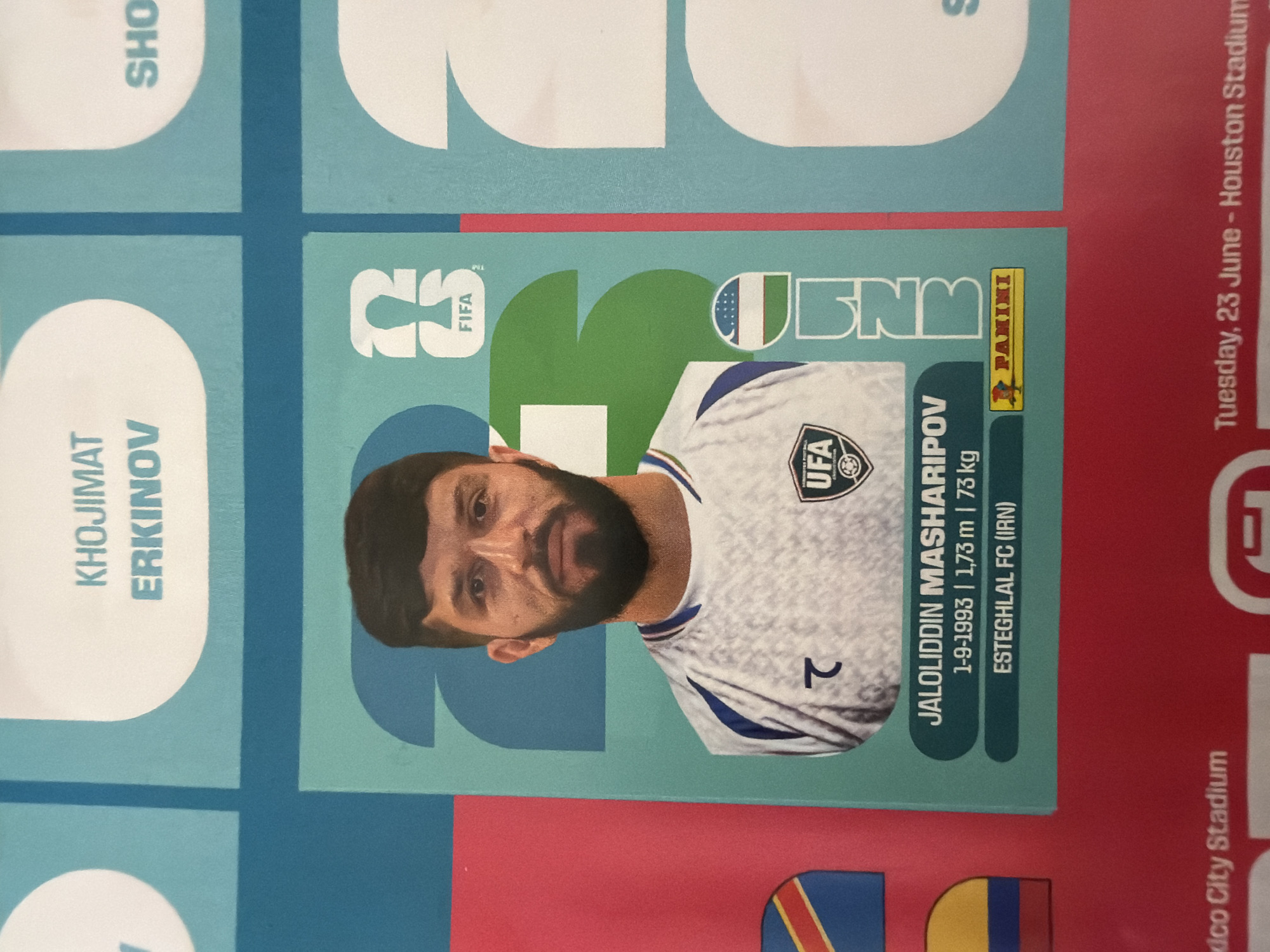 The image is a close-up of a soccer trading card, featuring a portrait of a male soccer player. The player has dark hair, a beard, and is wearing a white jersey with blue accents and a crest on the chest. Text on the card includes the player's name, "JALOLIDDIN MASHARIPOV," followed by his birthdate, height, and weight. Below this, the team name, "ESTEGHLAL FC (IRN)," is listed. A Panini logo is visible in the bottom right corner of the card. The background of the card is a light teal color with abstract shapes. The trading card is placed on a larger surface, possibly a page from a sticker album, which has a red border at the bottom and a turquoise grid pattern. Text at the bottom of the larger surface reads "Mexico City Stadium" and "Tuesday, 23 June - Houston Stadium." The question about Zlatitrap, Bulgaria is not relevant to the content of the image itself.