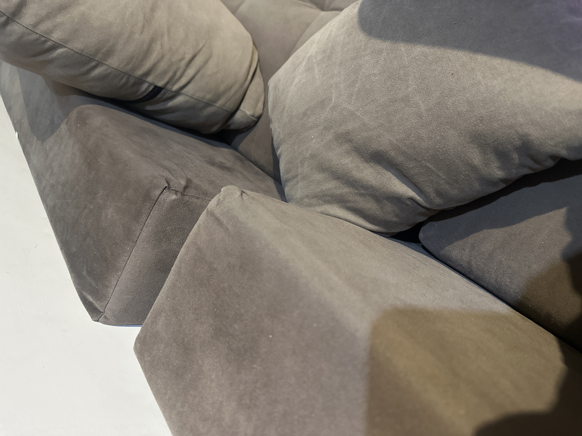 The image shows a close-up of a modular gray sofa. It features large, soft cushions and angular, upholstered bases. The location is not discernible from the image, and there is no information to suggest it is in Rakovski, Bulgaria. There are no people visible in the scene.