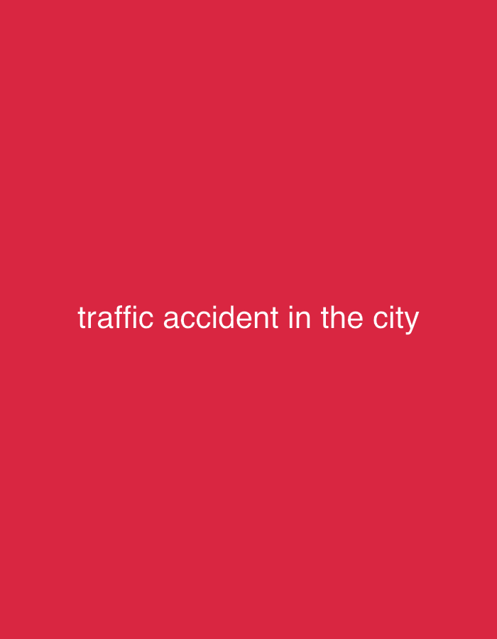 The image displays a solid, vibrant red background. White sans-serif text is centered horizontally in the lower portion of the frame, reading "traffic accident in the city". No other visual elements are present, such as people, objects, vehicles, or specific city details. The image does not depict an actual scene but functions as a text-based title card or informational graphic. The uniform red background offers no cues regarding the time of day, weather, or specific location. The provided context indicates that the event referenced by the text, "traffic accident in the city," is associated with Kharkiv, Ukraine.