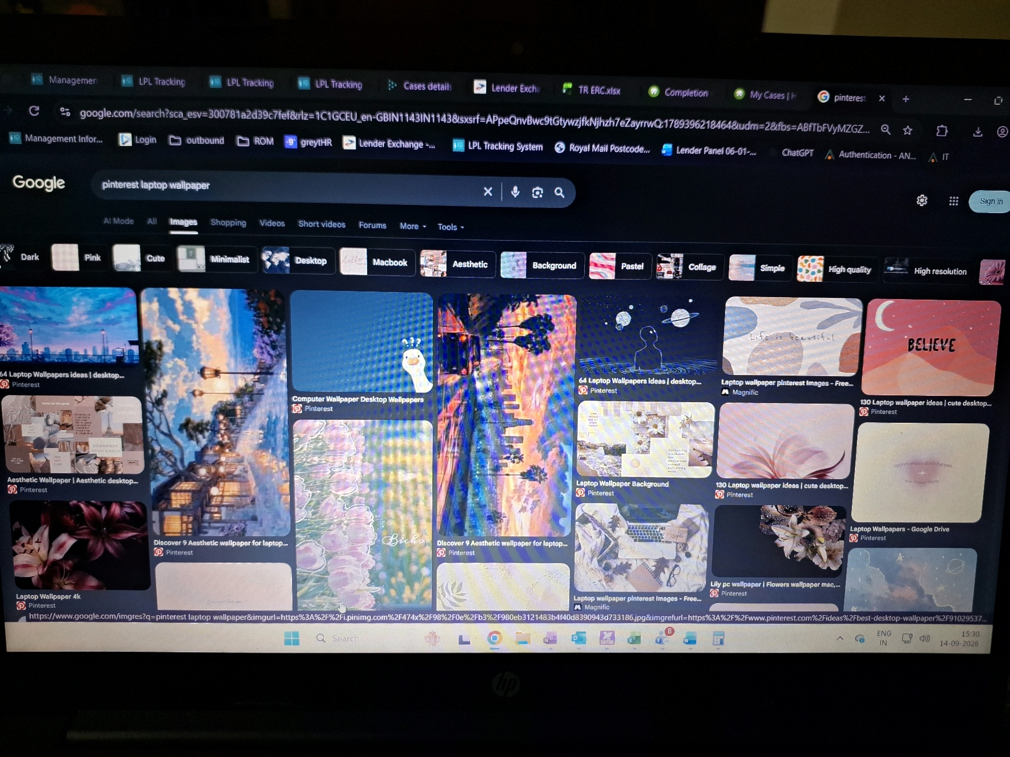 The image shows a laptop screen displaying a Google search results page for "pinterest laptop wallpaper". The search results are presented as a grid of image thumbnails. The browser tabs at the top show various websites related to "LPL Tracking" and "Lender Exchange". The operating system taskbar at the bottom displays the time as 15:30 and the date as 14-09-2026. There is no indication of the city of Yamunanagar, India, or any specific location within it being present in the image. The scene depicts a digital environment and does not contain any physical elements that could be tied to a geographical location.