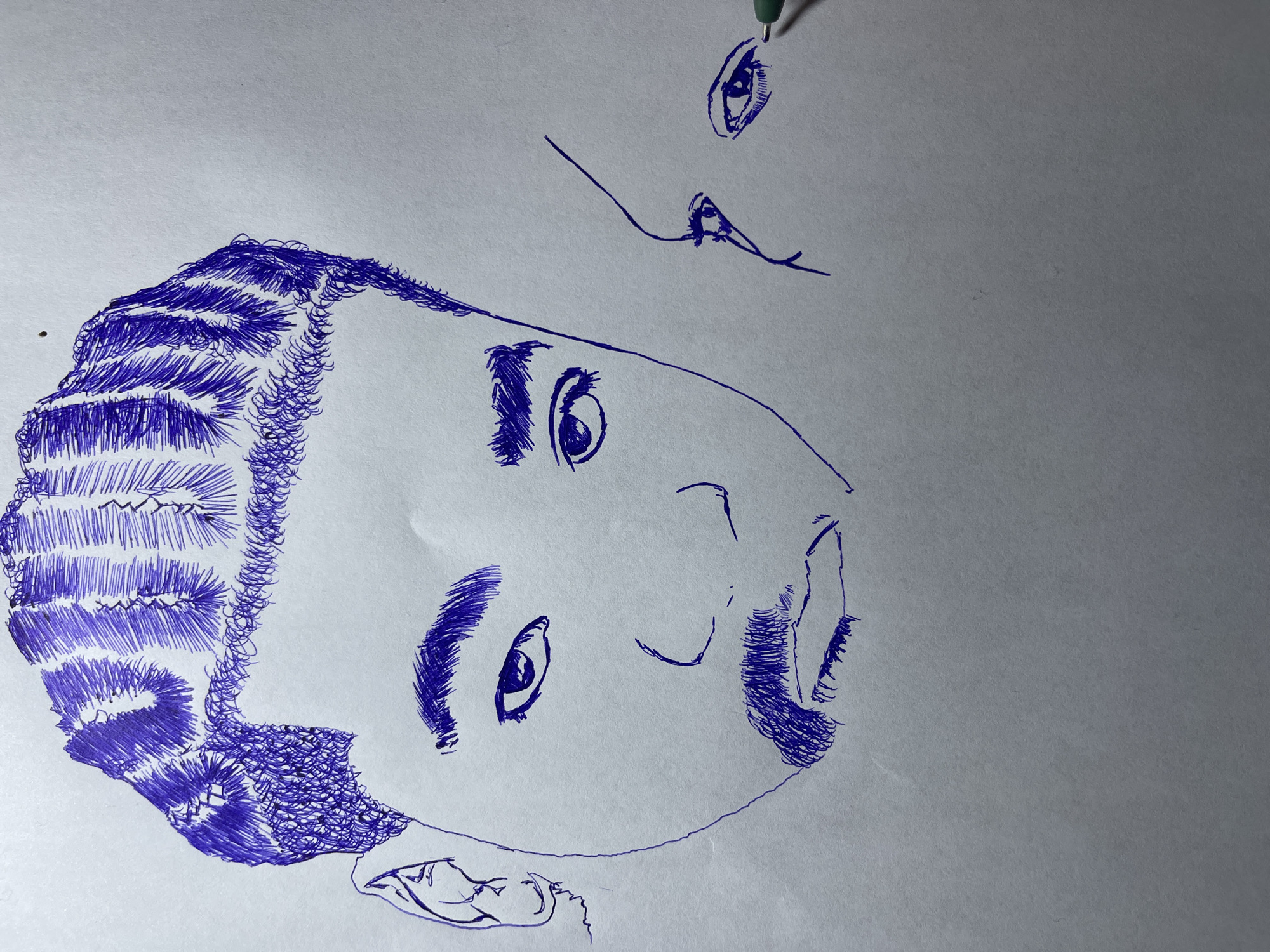 This is a pen drawing on a light-colored, textured paper. The drawing features a close-up, frontal portrait of a young man, likely in his late teens or early twenties, occupying the left and central portion of the image. His hair is styled in intricate braids, with finer textured hair at the temples and sides. He has a prominent mustache and goatee. His gaze is directed forward, with his left eye appearing slightly larger and more detailed than his right. The facial features are rendered with bold, sketchy lines, and there is a significant amount of cross-hatching used to depict shading and texture, particularly in the hair and facial hair.
To the right of the central figure, and slightly behind, is a partial drawing of another face, focusing on the eye and cheekbone area. This second face is also rendered with pen lines, and its eye is looking towards the right of the frame, with visible eyelashes. A green pen tip is visible near this eye, suggesting it might be the tool used for the drawing, or it's part of the drawing process. The background is plain white paper, with no discernible environmental elements. The overall style is raw and expressive, with a focus on capturing the likeness and texture of the subjects through line work. There is no indication of the city of Jos, Nigeria, in the image itself.