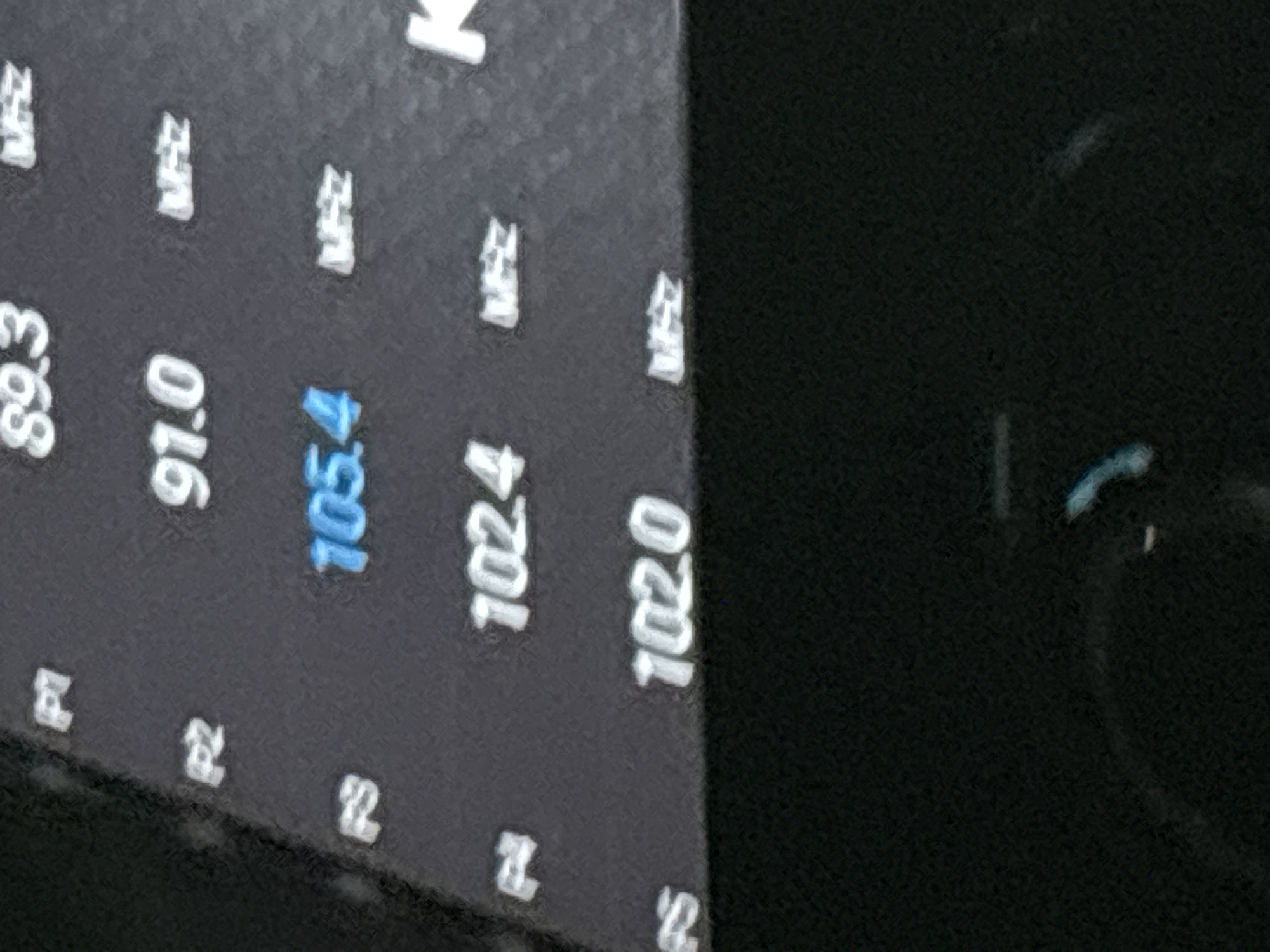 The image shows a close-up view of a digital display, likely from a car radio or other electronic device. The display shows a list of numbers, predominantly in white, with one number in blue. Some of the numbers are accompanied by the letters "MHz". On the left side of the display, there are labels "P1", "P2", and "P3". The background is dark, and the overall image quality is somewhat grainy. The specific context of Grozny, Russia, is not evident from the visual information presented in the image itself.
