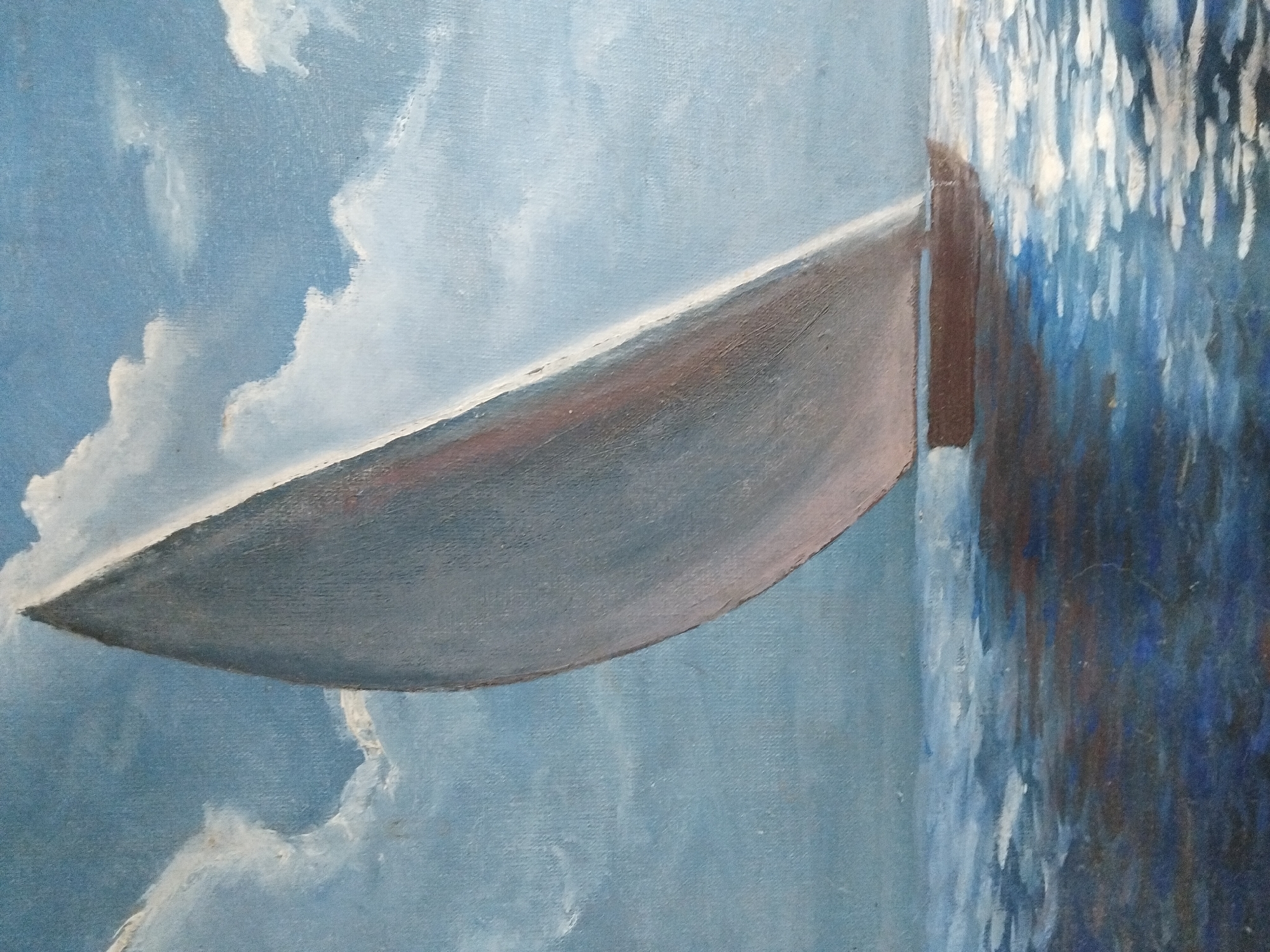 This is an oil painting on canvas depicting a sailboat with a large sail against a backdrop of a blue sky with white clouds. The sailboat is positioned in the lower half of the painting, leaning to the right. The water below is depicted with a textured surface, reflecting the sky and the sail. The colors are predominantly blues and whites, with some warmer tones on the sail and the hull of the boat. The painting appears to be a seascape. There is no indication of any specific location in Kyiv, Ukraine, within the artwork itself.