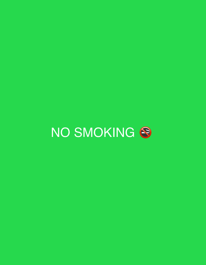 The image displays a solid, uniform green background. Centered horizontally and slightly below the vertical midpoint, the white text "NO SMOKING" is presented in an uppercase, sans-serif typeface. Immediately to the right of the text is a universally recognized "No Smoking" symbol, depicted as a red circle with a diagonal line bisecting a lit cigarette. No people, specific objects beyond the text and symbol, or actions are depicted. The green background appears consistent with a digital display or a chroma key screen. There are no visual elements within the image that indicate a specific physical location in the city of Saraia, Bulgaria, or any other real-world environment.