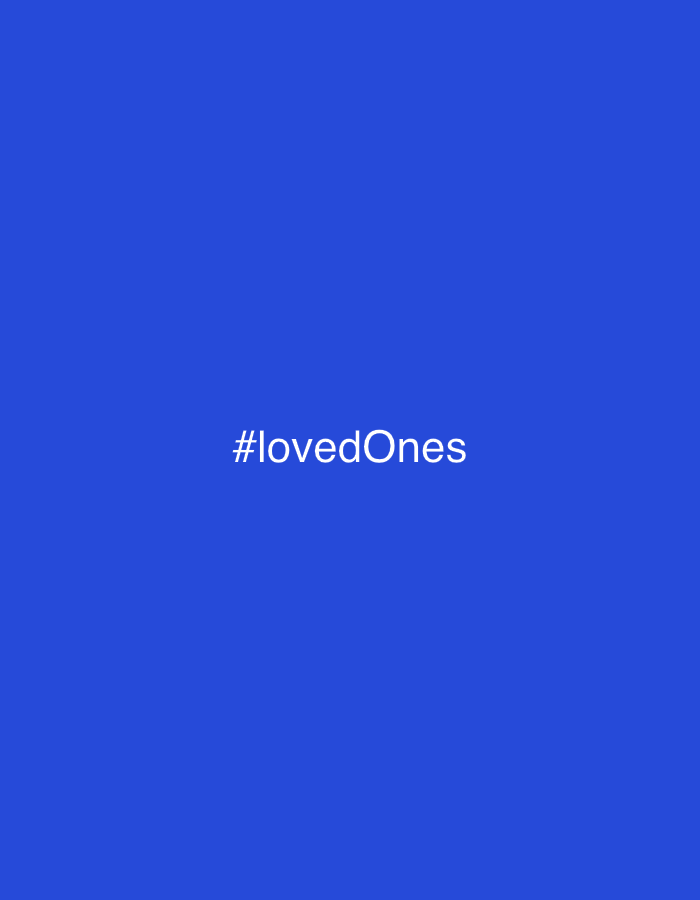 The image features the white text "#lovedOnes" centered against a solid, vibrant blue background. There are no other subjects, objects, or discernible scenes depicted. The background is a uniform shade of blue, devoid of textures or patterns. No specific time of day, weather conditions, or geographical location cues are visible within the image itself. The text, presented as a hashtag, evokes themes of affection, family, friends, and personal connections. Despite the provided context of Barcelona, Spain, the visual content of the image does not offer any specific indicators of this or any other physical location. The overall aesthetic is minimalist, focusing entirely on the textual message against a plain colored field.