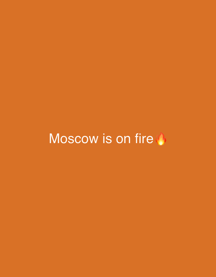 The image is a screenshot of a social media post with an orange background. White text in the center of the image reads "Moscow is on fire ๐ฅ". There is no indication of the city of Kaunas, Lithuania, in the image.