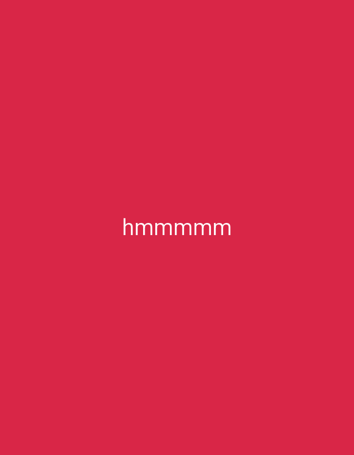 A minimal, centered photograph features the word "hmmmmm" in white text against a solid crimson background. There are no people, objects, or environmental features present in the image, nor is there any indication of its location in Wajak Kidul, Indonesia.