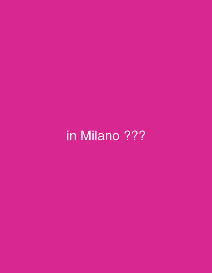 The image displays a solid fuchsia background. Centered on this background is white text, rendered in a sans-serif typeface, which reads: 'in Milano ???'. There are no other visible subjects, objects, people, or discernible actions. The environment consists solely of the uniform fuchsia color. The location is in the city of Paris, France.