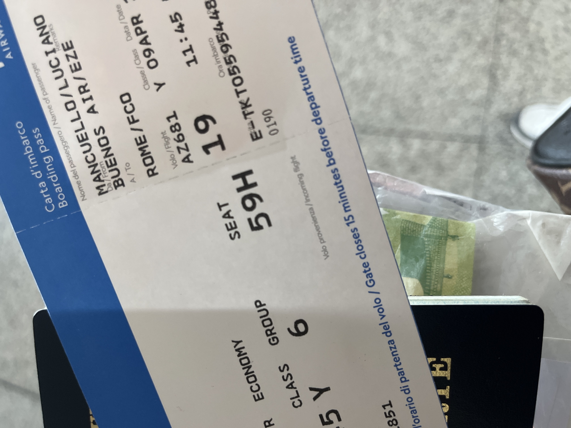 The image shows a boarding pass with the name MANCUELLO/LUCIANO for a flight on Aerolineas Argentinas, from Rome (FCO) to Buenos Aires (EZE) on April 9. The flight number is AZ681, the class is Y, and the seat number is 59H. The boarding group is 6. The gate closes 15 minutes before the 11:45 departure. The Aeropuerto Internacional Ezeiza, Argentina is the destination.